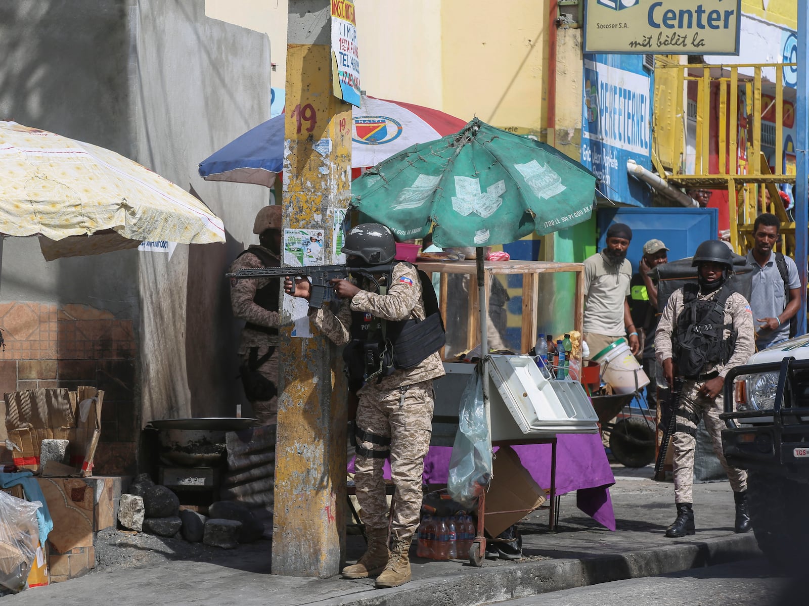 Police officers patrol a street during an exchange of gunfire between gangs and police in Port-au-Prince, Haiti, Monday, Nov. 11, 2024. (AP Photo/Odelyn Joseph)