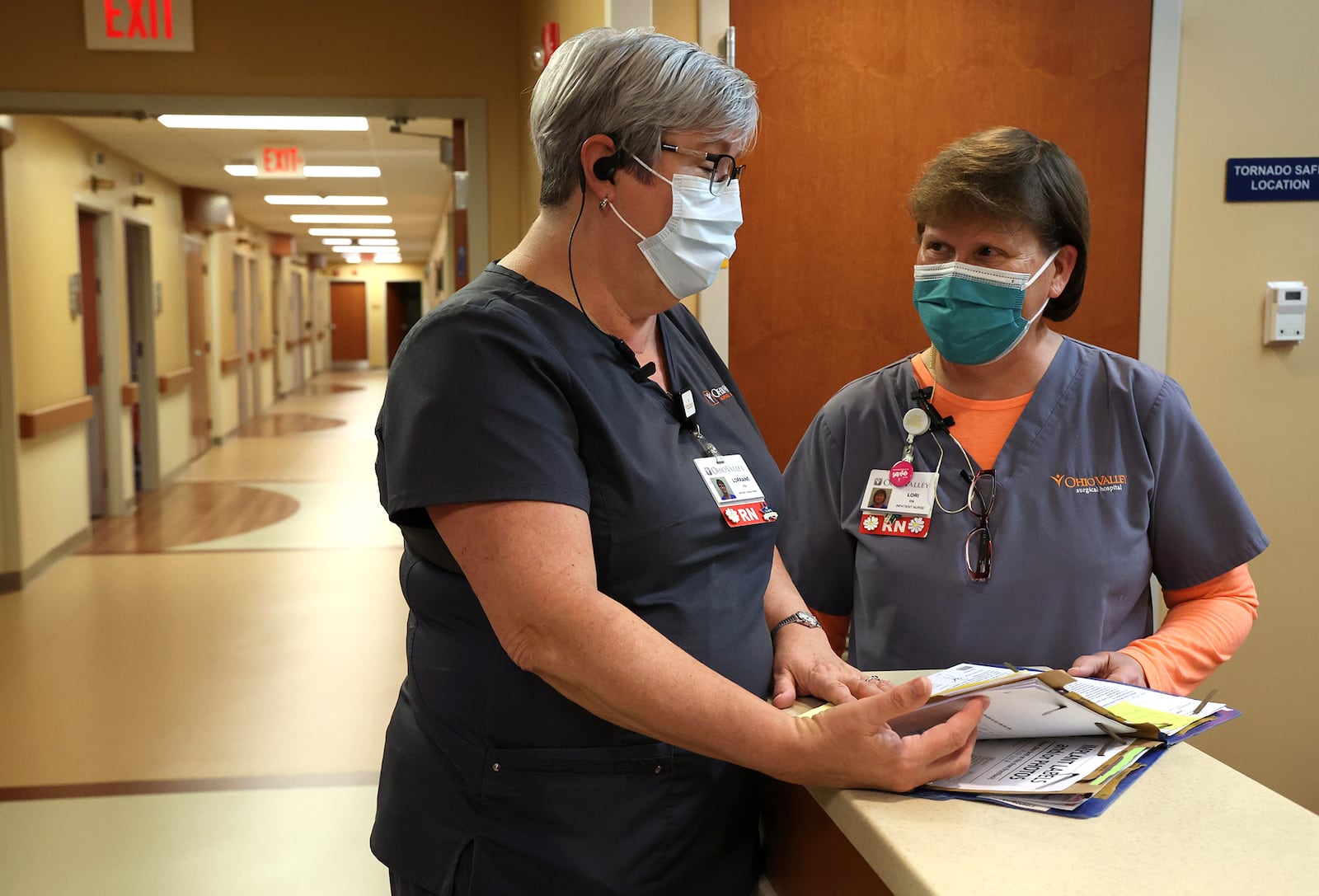 Nurses confer over a patient's chart Tuesday, Jan. 4, 2022 at the Ohio Valley Surgical Hospital.  BILL LACKEY/STAFF