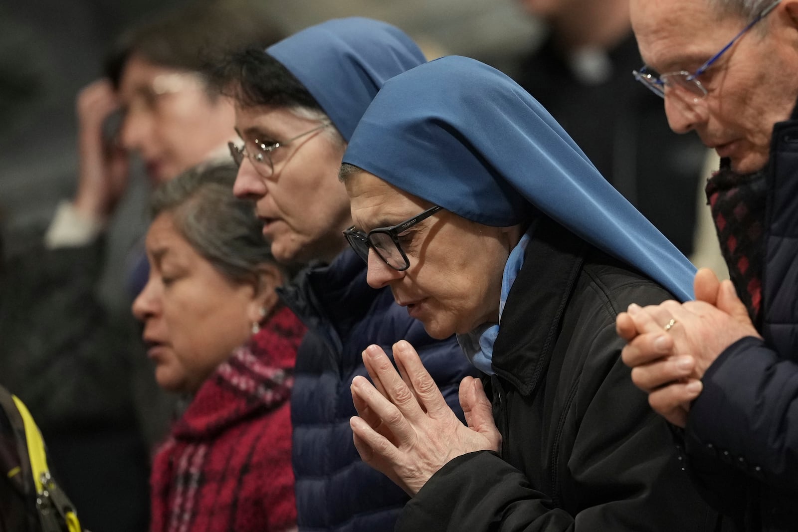 Faithful and nuns gather at St. John Lateran Basilica in Rome Sunday, Feb. 23, 2025, to pray for Pope Francis who was admitted over a week ago at Rome's Agostino Gemelli Polyclinic and is in critical condition. (AP Photo/Alessandra Tarantino)