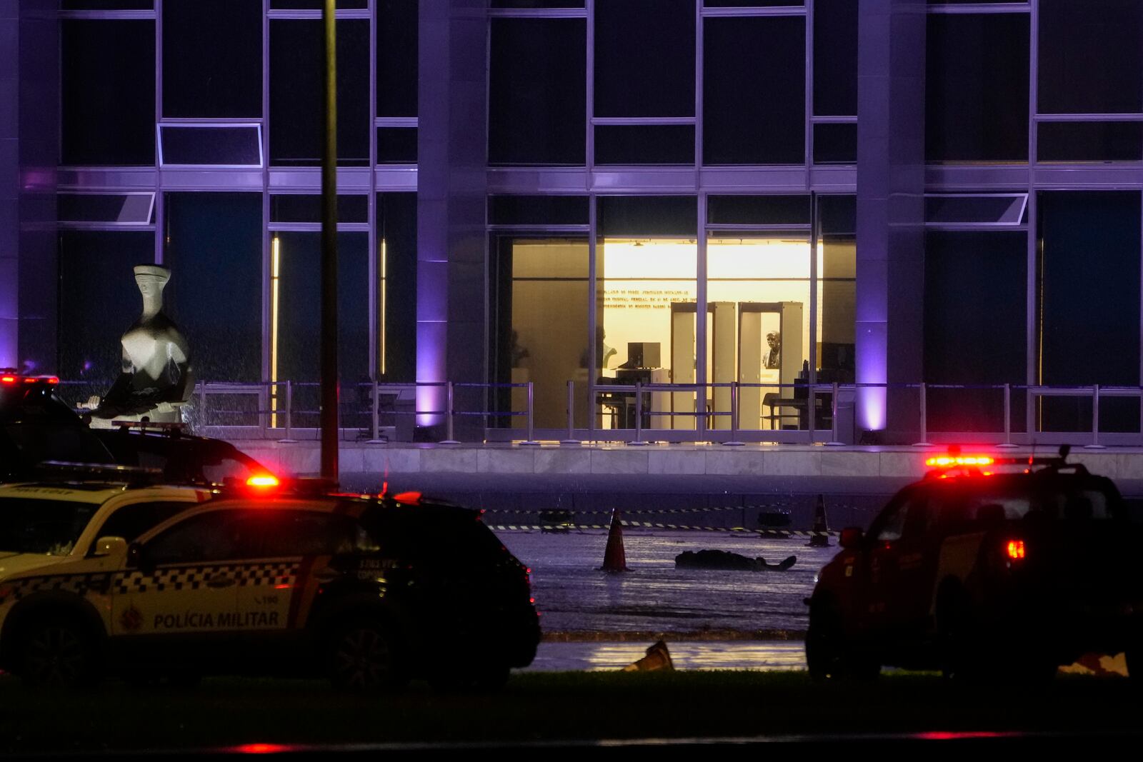 A body lies outside the Supreme Court in Brasília, Brazil, following an explosion, Wednesday, Nov. 13, 2024. (AP Photo/Eraldo Peres)