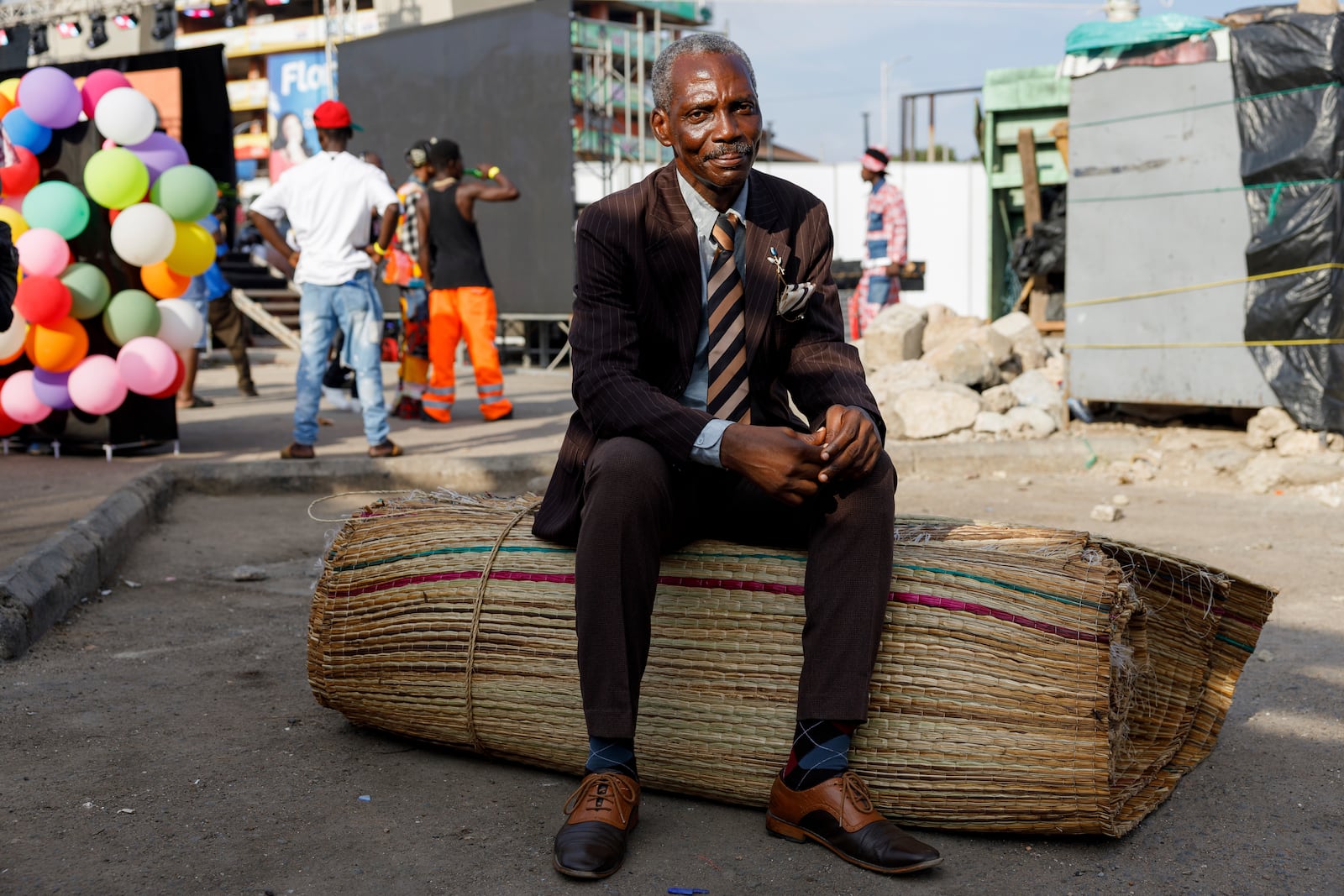 A man dressed in second-hand clothes attends a thrift and an upcycle show in Accra, Ghana, Sunday, Oct. 27, 2024. (AP Photo/Misper Apawu)