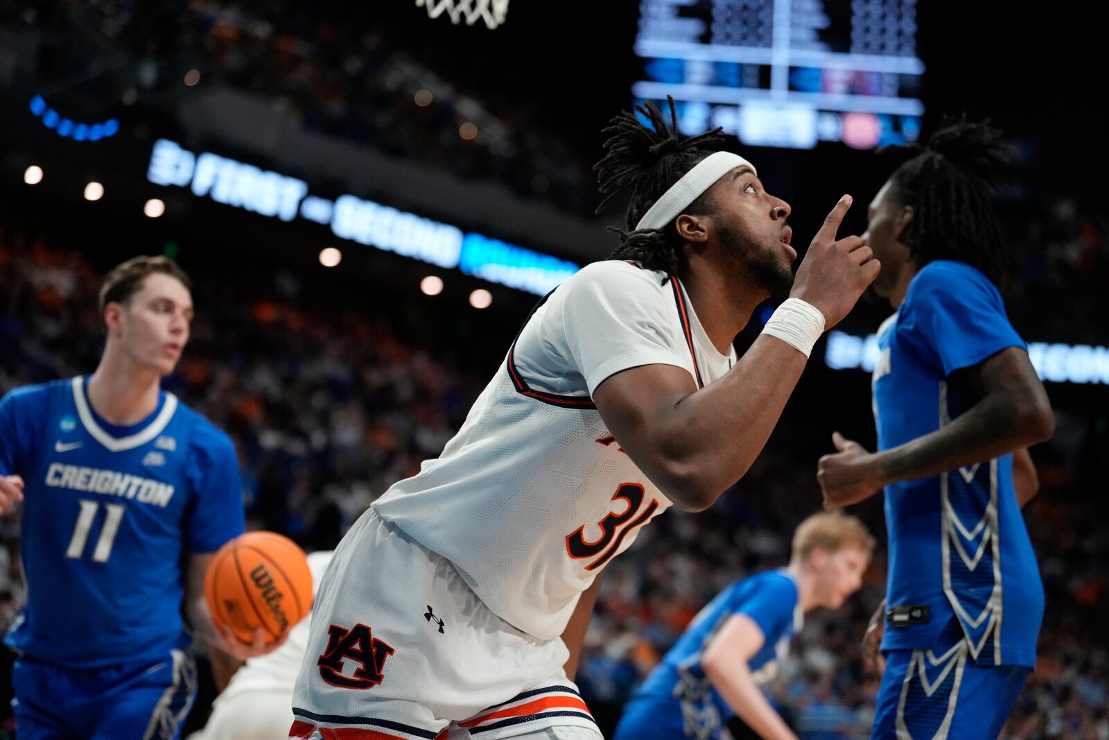 Auburn forward Chaney Johnson (31) celebrates after he shoots and scores during the first half in the second round of the NCAA college basketball tournament against Creighton, Saturday, March 22, 2025, in Lexington, Ky. (AP Photo/Brynn Anderson)