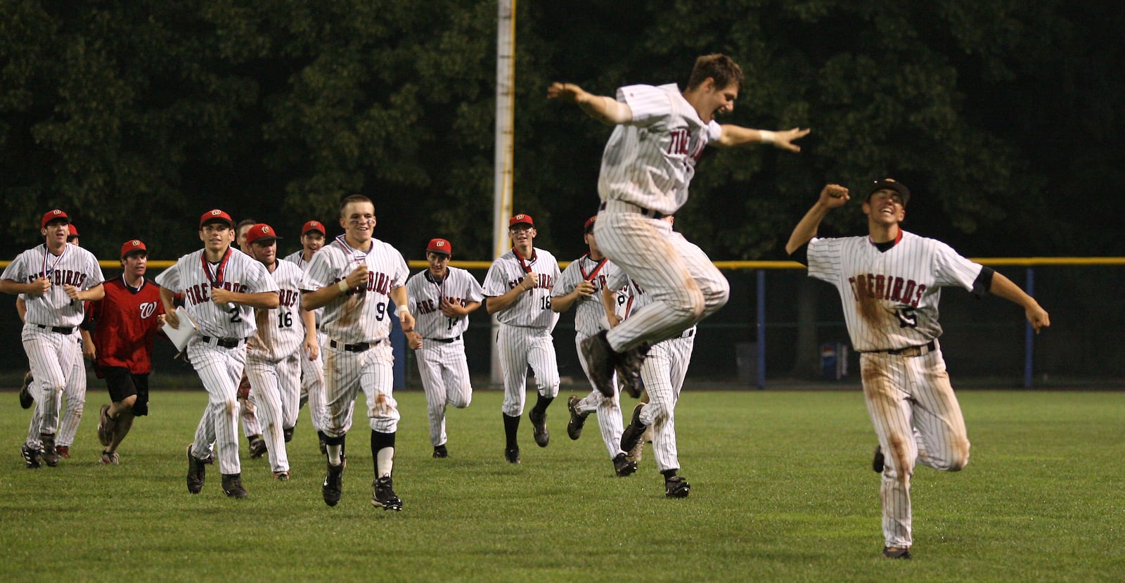 Dustin Huff (left) and Brad Gschwind jump during their celebratory lap, after defeating Mentor in the state title game Sunday morning at Cooper Stadium in Columbus. JOURNAL-NEWS FILE PHOTO