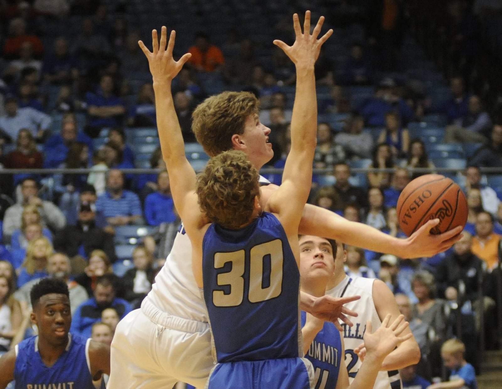 Brookville’s Jacob Gudorf gets off a shot past Summit Country Day’s Sam Martin during a Division III district final March 9, 2017, at the University of Dayton Arena. Summit won 72-50. MARC PENDLETON/STAFF