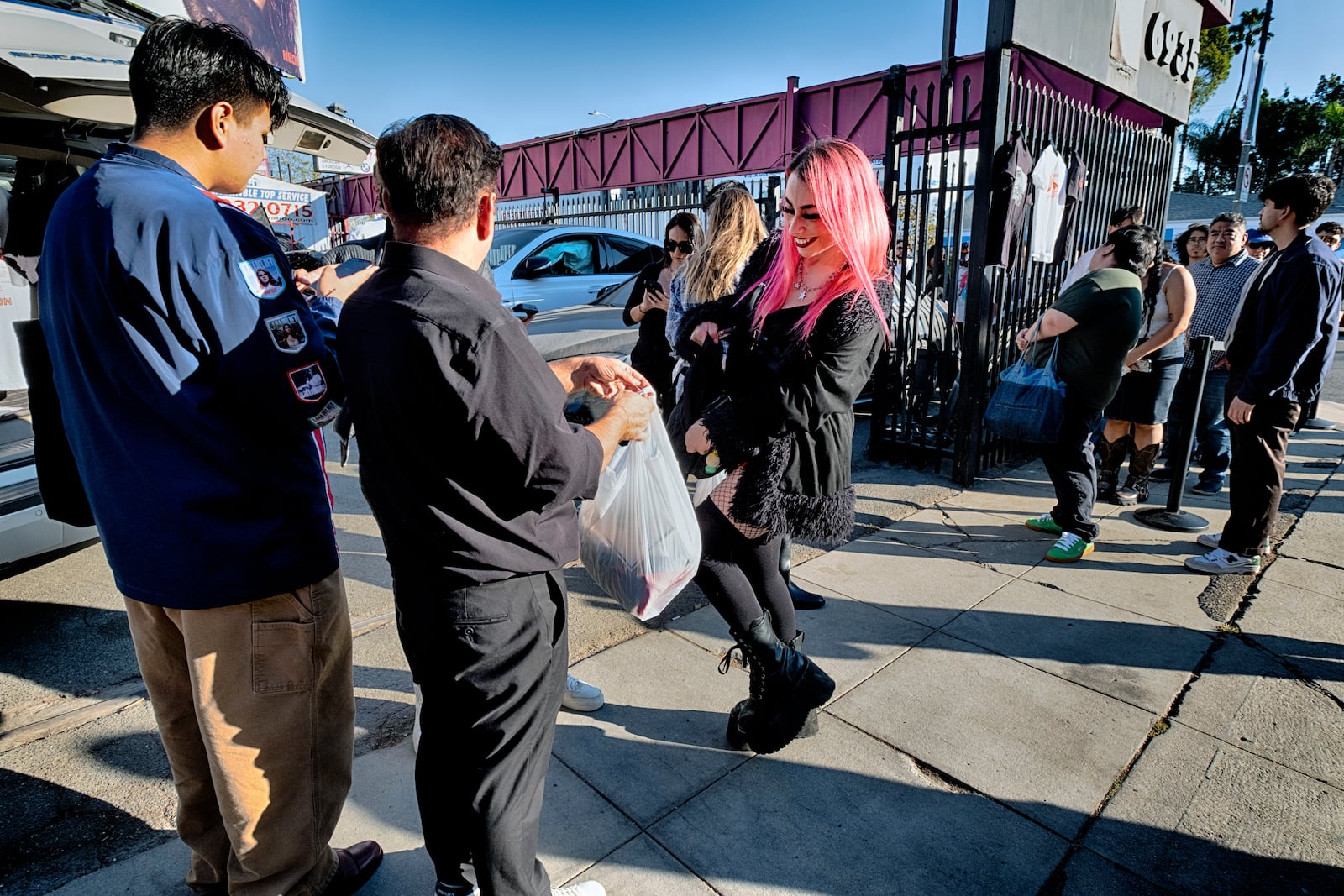 An Sabrina Bratt, movie fan receives her tee-shirts during a merchandise Pop-Up event for the newly released movie Anora on Saturday, Nov. 9, 2024 in Los Angeles. (AP Photo/Richard Vogel)