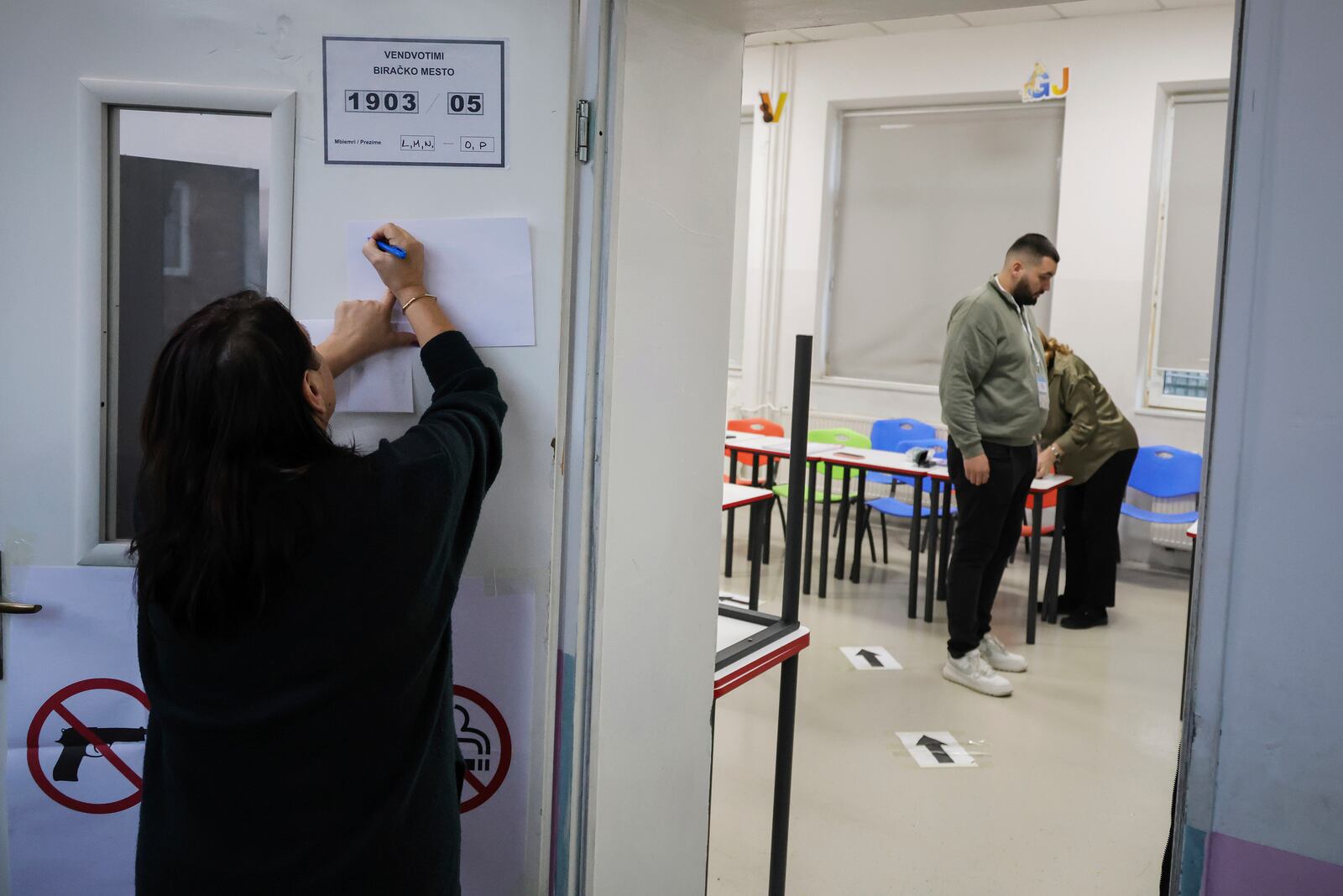 An electoral committee member prepares a voting station for a parliamentary election in Pristina, Kosovo, Sunday, Feb. 9, 2025. (AP Photo/Vlasov Sulaj)