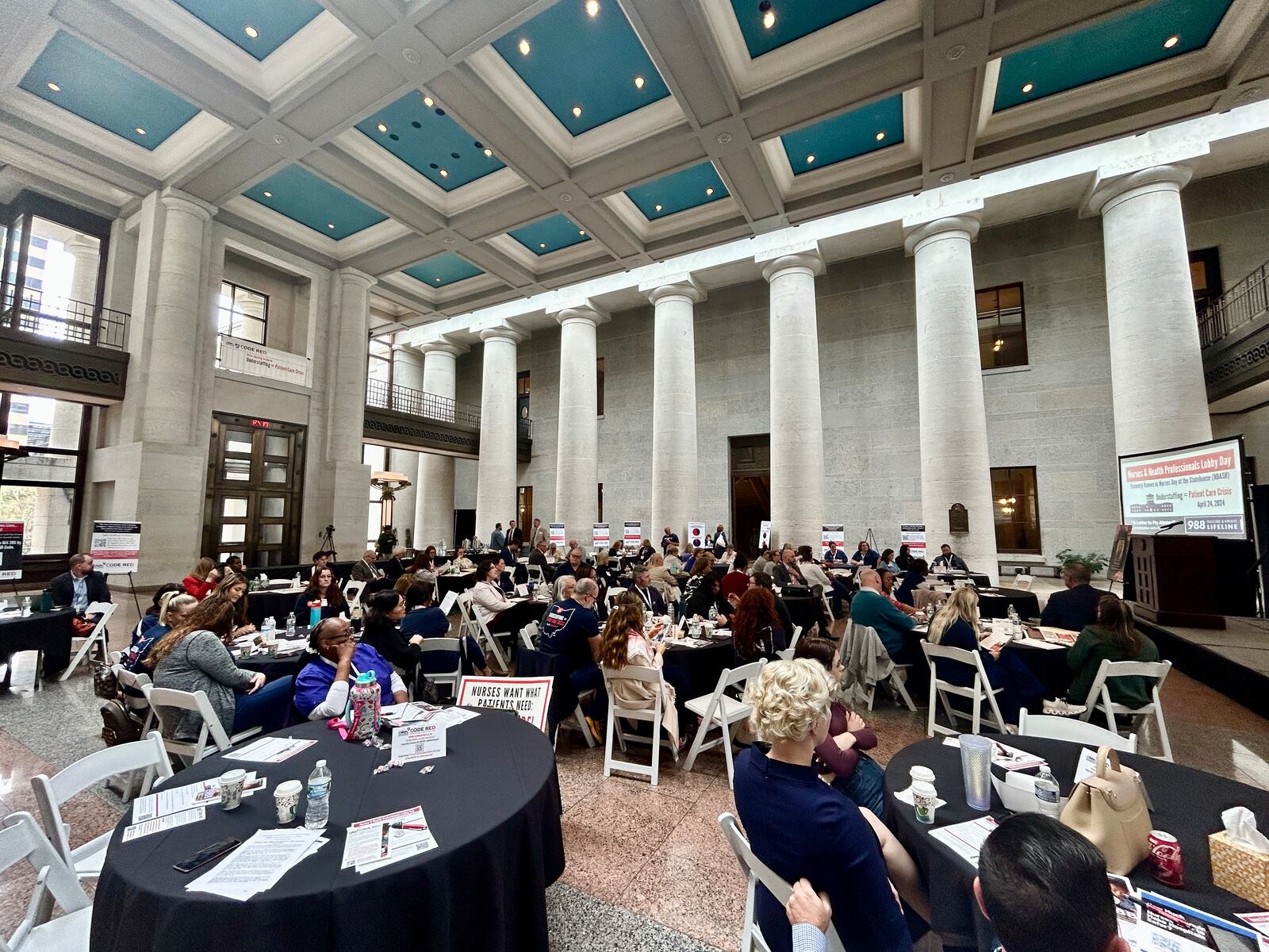 A group of nurses and advocates gathered on Wednesday, April 24, 2024, in the Ohio Statehouse Atrium to pressure lawmakers into passing a bill that would require mandatory nurse-to-patient minimums in Ohio hospitals. AVERY KREEMER/STAFF