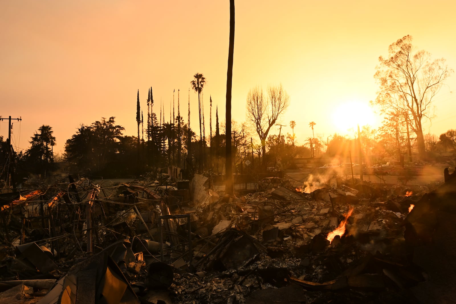 The sun sets over damage from the Eaton Fire, Thursday, Jan. 9, 2025, in Altadena, Calif. (AP Photo/Nic Coury)