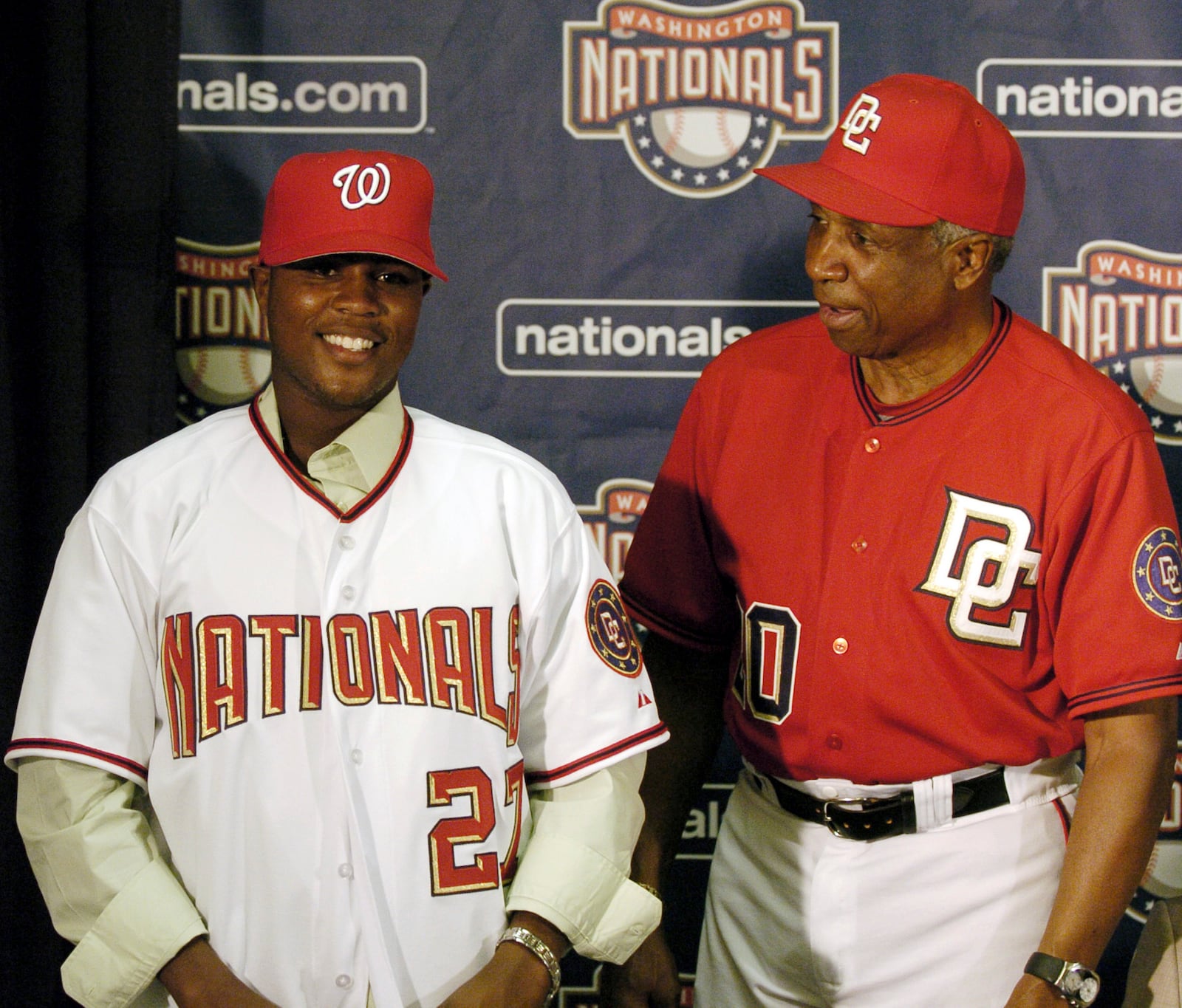 FILE - Washington Nationals manager Frank Robinson, right, introduces Dominican Esmailyn González, an amateur free-agent shortstop who had taken four years off his age to appear younger, at a media presentation in Washington, July 2, 2006. Carlos Álvarez, formerly known as Esmailyn "Smiley" González, played for three years with the Washington Nationals before the MLB learned that he was lying about his age. (AP Photo/Nick Wass, File)