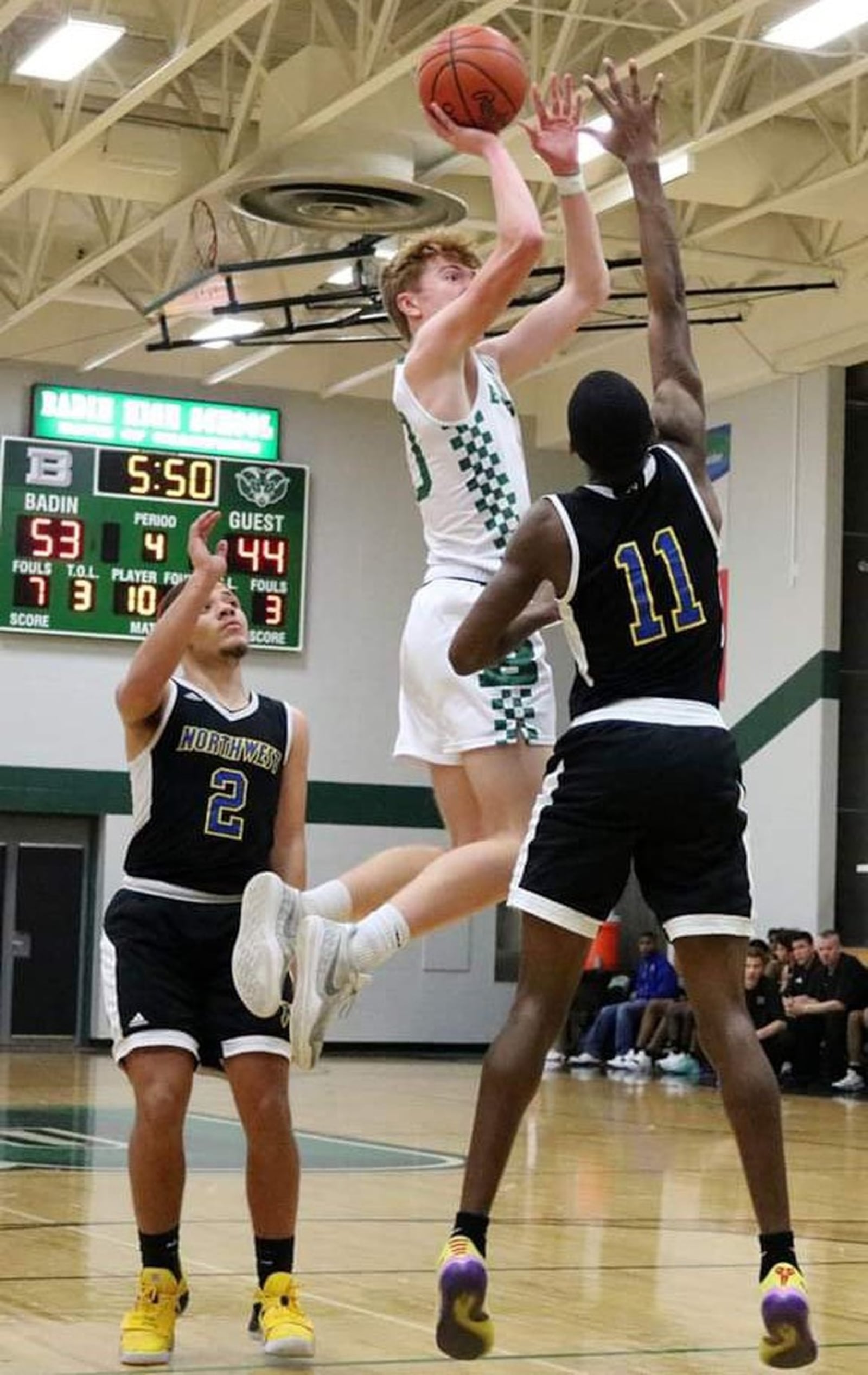 Badin’s Zach Switzer (10) shoots between Northwest’s Isaiah Loveless (2) and Keyshawn Bourrage (11) during Tuesday night’s game at Mulcahey Gym in Hamilton. Badin won 70-52. CONTRIBUTED PHOTO BY TERRI ADAMS