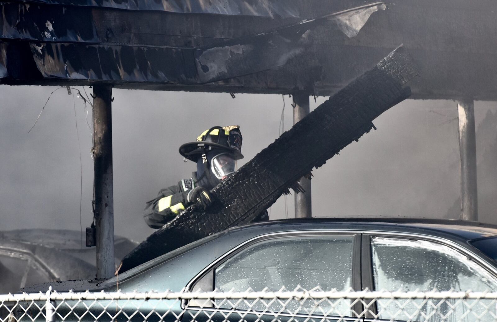 Several cars were heavily burned in a fire at a garage behind apartments on Arlington Avenue in Hamilton on Monday, Feb. 25, 2019. NICK GRAHAM / STAFF