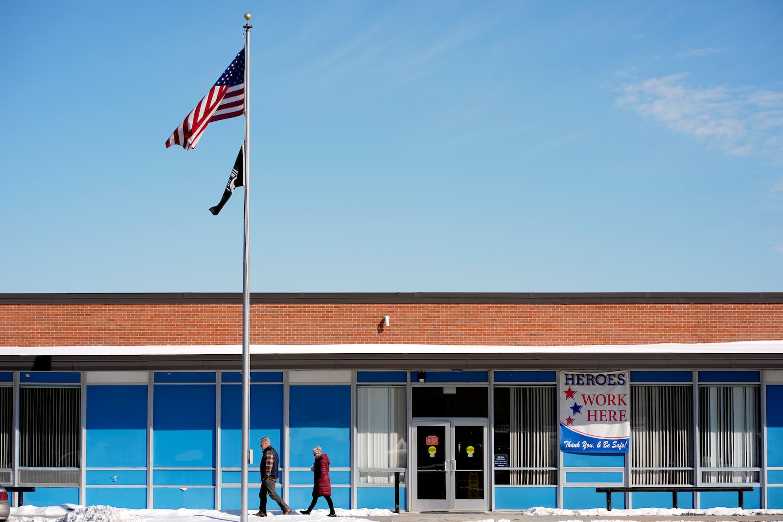 People leave a U.S. post office, Friday, Feb. 21, 2025, in Mission, Kan. (AP Photo/Charlie Riedel)