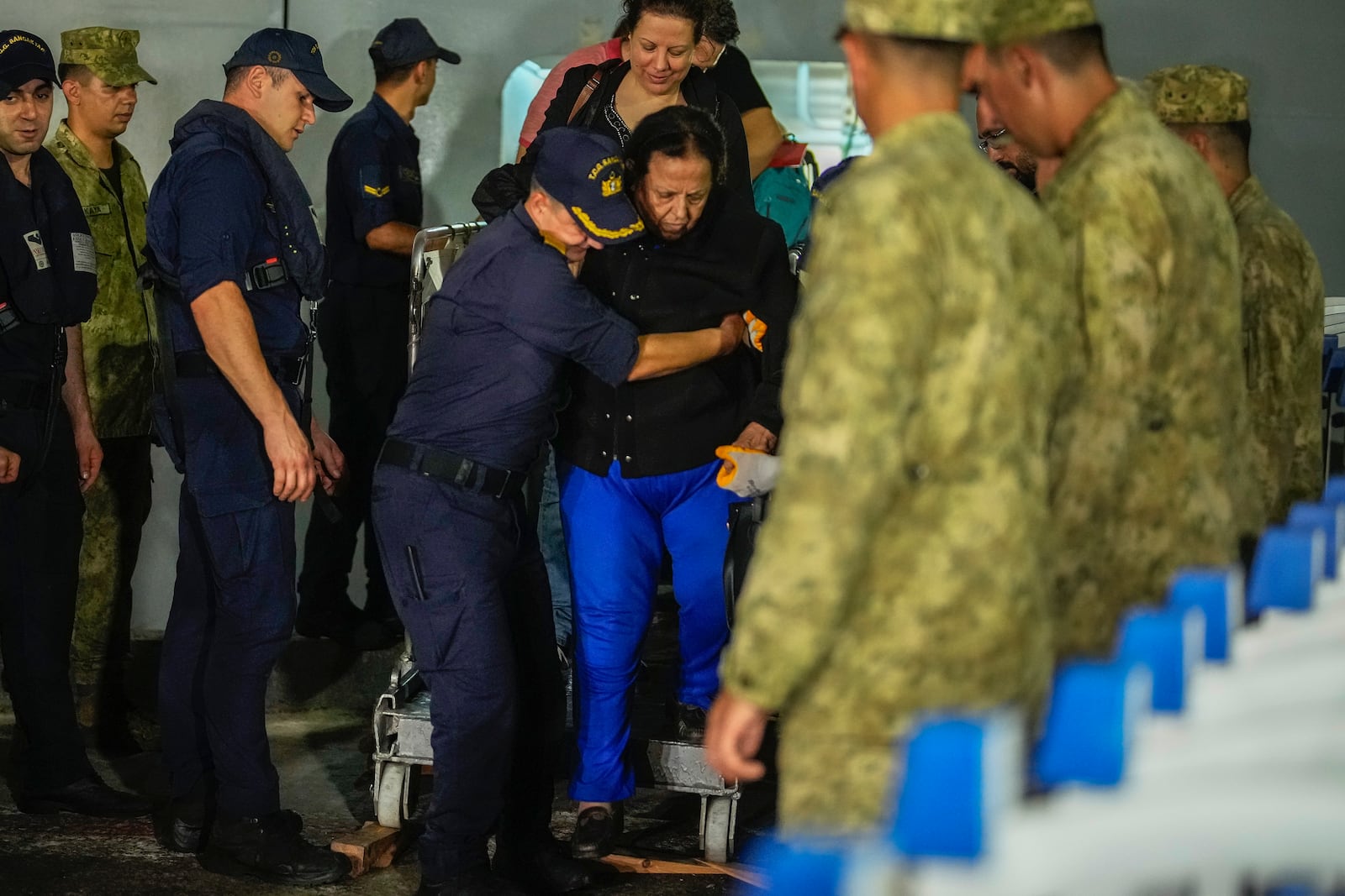 People mostly Turkish nationals disembark from Turkish TCG Sancaktar military ship after being evacuated from Lebanon's capital Beirut to Turkey, in Mersin port, southern Turkey, early Friday, Oct. 11, 2024. (AP Photo/Emrah Gurel)