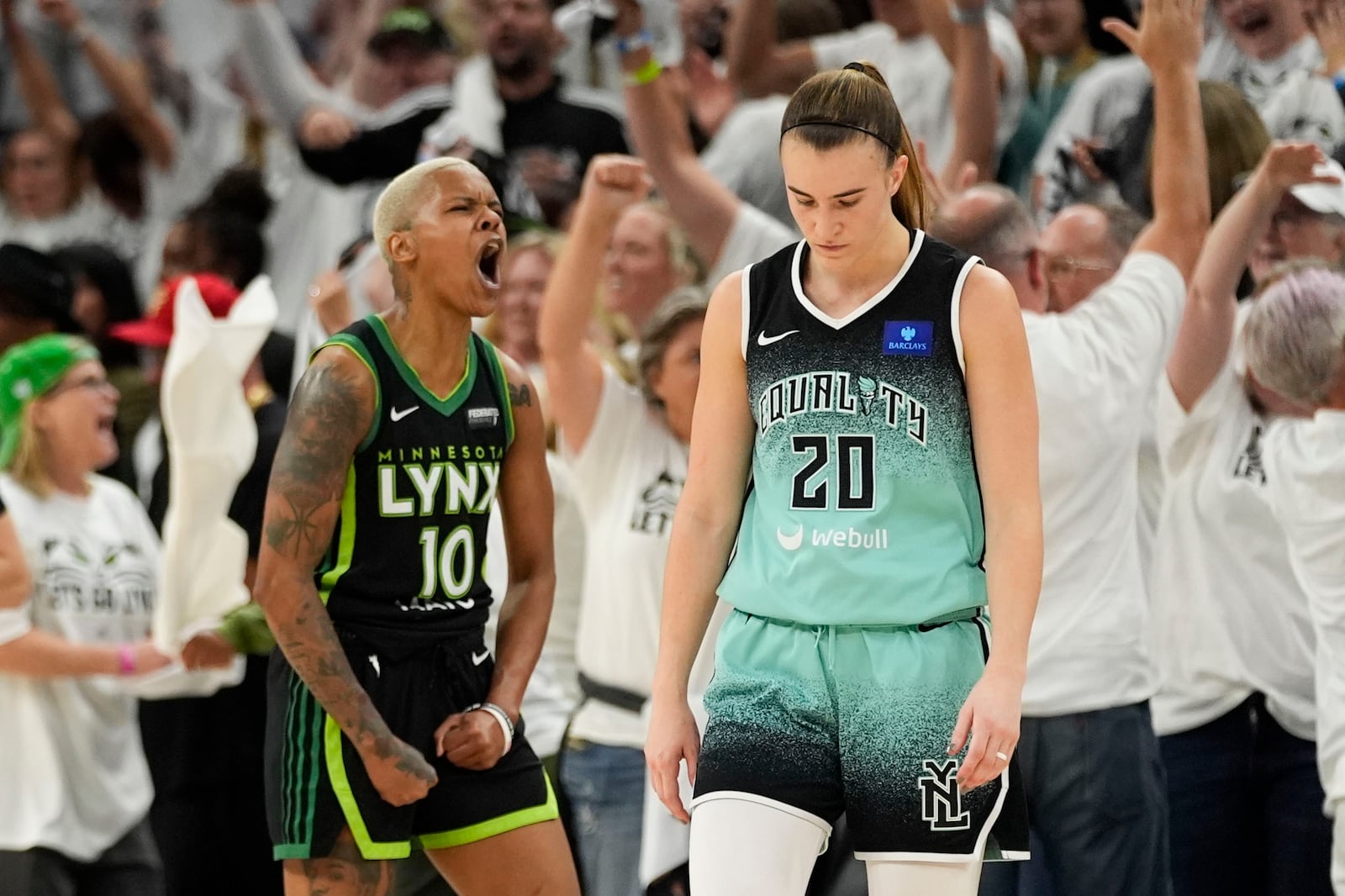 New York Liberty guard Sabrina Ionescu (20) reacts after missing a shot at the buzzer, as Minnesota Lynx guard Courtney Williams (10) celebrates during the second half of Game 4 of a WNBA basketball final playoff series, Friday, Oct. 18, 2024, in Minneapolis. The Lynx won 82-80, forcing a Game 5 in the series. (AP Photo/Abbie Parr)