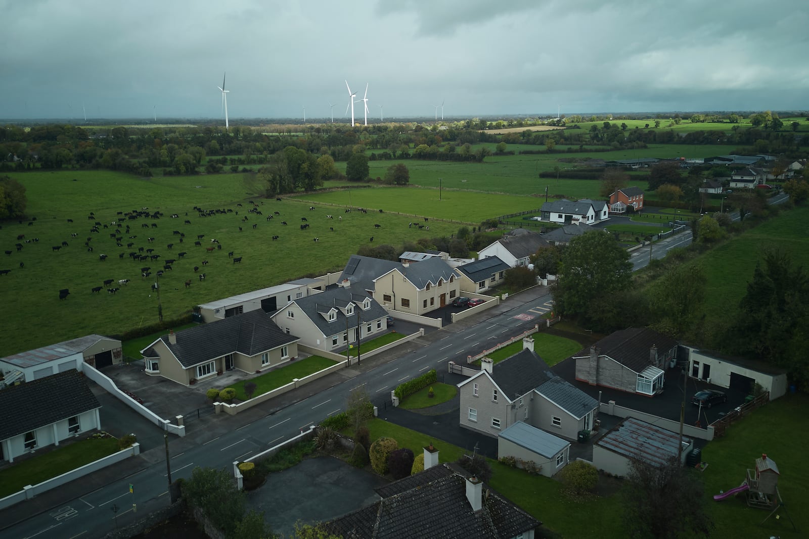 Wind turbines can be seen from the village of Rhode, Ireland, Thursday, Oct. 17, 2024. (AP Photo/Bram Janssen)