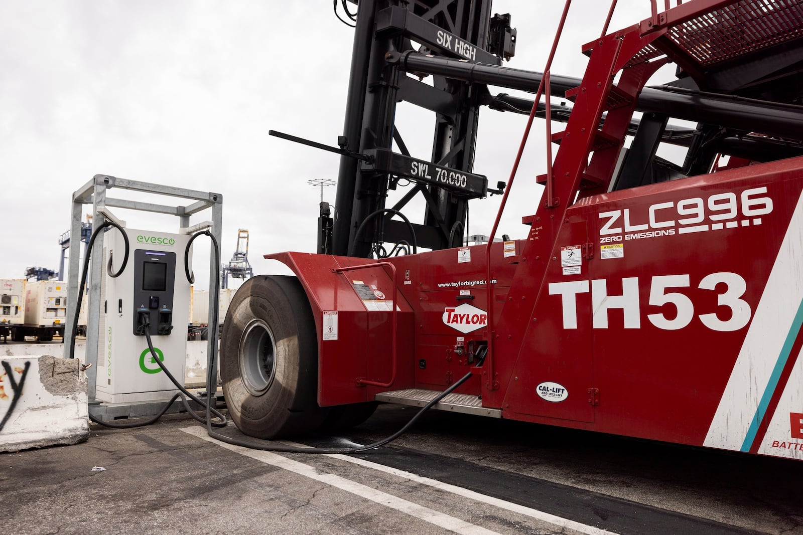 An electric top-handler is charging at a station at the Yusen Terminal in the Port of Los Angeles, Tuesday, March 11, 2025, in San Pedro, Calif. (AP Photo/Etienne Laurent)