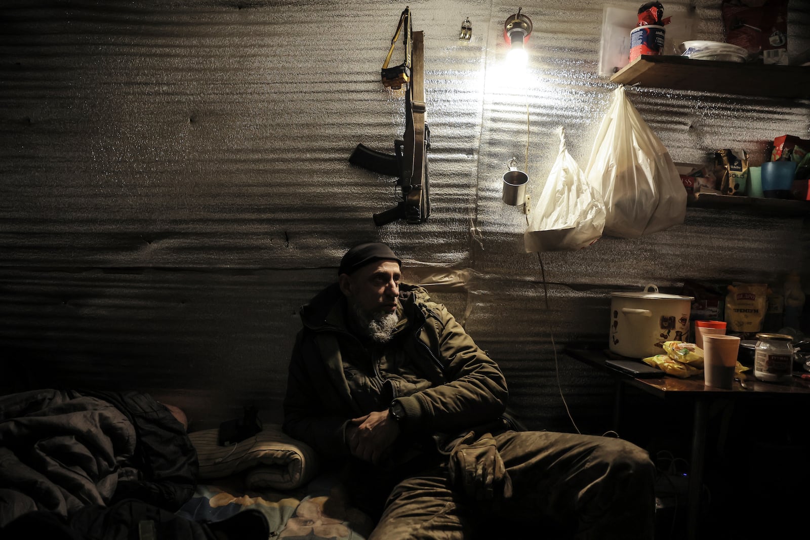 In this photo provided by Ukraine's 24th Mechanised Brigade press service, servicemen rest on the front line near Chasiv Yar, Donetsk region, Ukraine, Thursday, Feb. 7, 2025. (Oleg Petrasiuk/Ukraine's 24th Mechanised Brigade via AP)