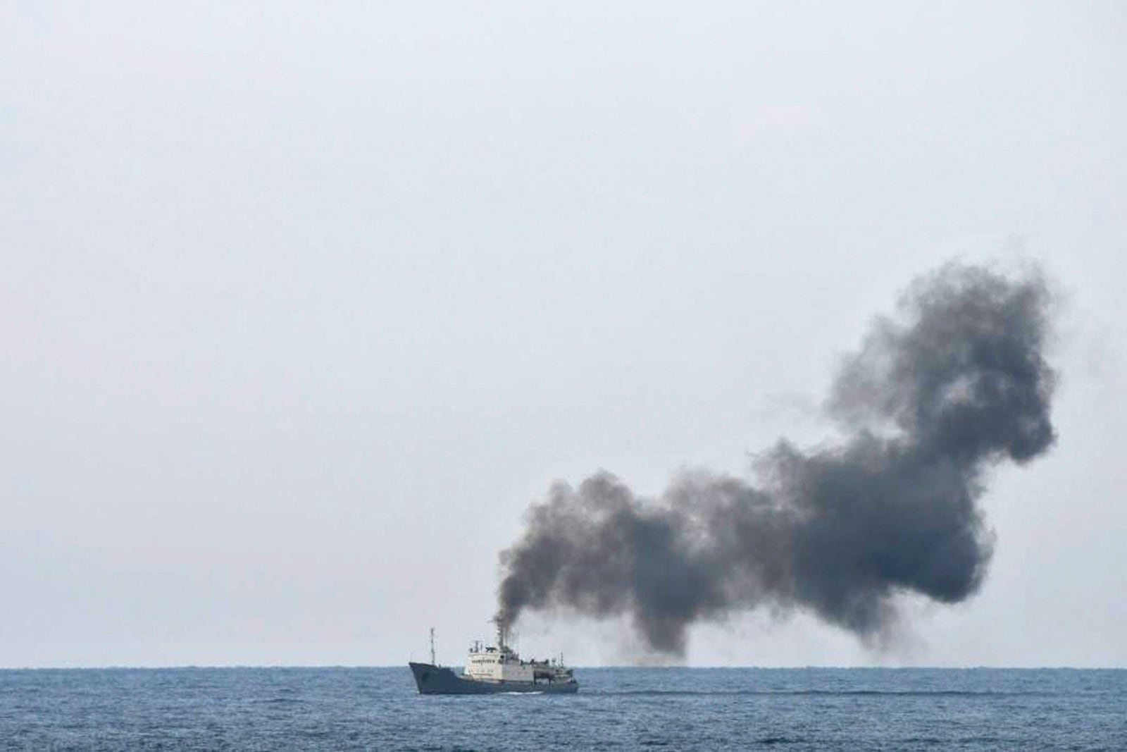 Military officials say this photo taken from a nearby vessel shows smoke rising from a fire aboard the Russian spy ship Kildin off the coast of Syria on Jan. 23, 2025. (AP Photo)