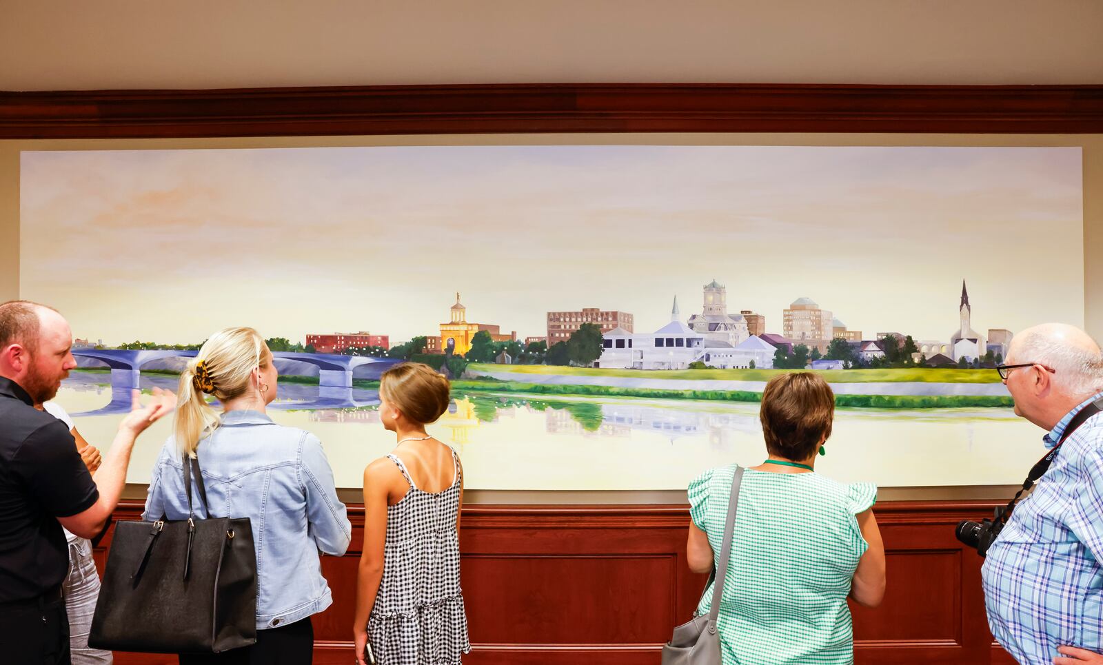 Family and friends look at a painting by artist Michelle Martin-McDulin unveiled Tuesday, Aug. 22, 2023 in the super courtroom at Butler County Common Pleas Court in Hamilton. The painting is 5 ft. tall and 15 ft. wide. NICK GRAHAM/STAFF