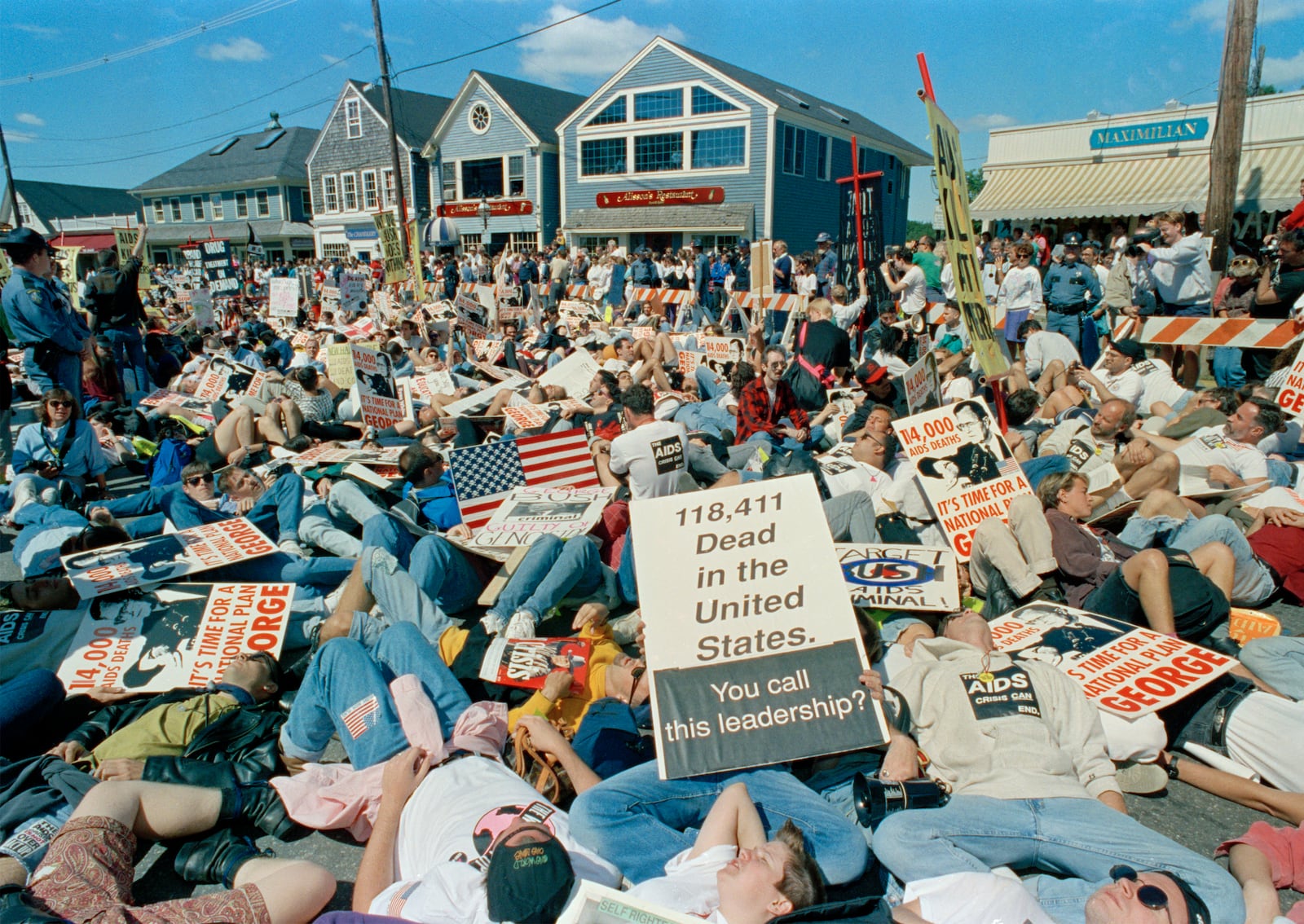 FILE - AIDS activists stage a mock "die-in" at Dock Square in downtown Kennebunkport, Maine, Sept. 1, 1991. (AP Photo/Greg Gibson, File)