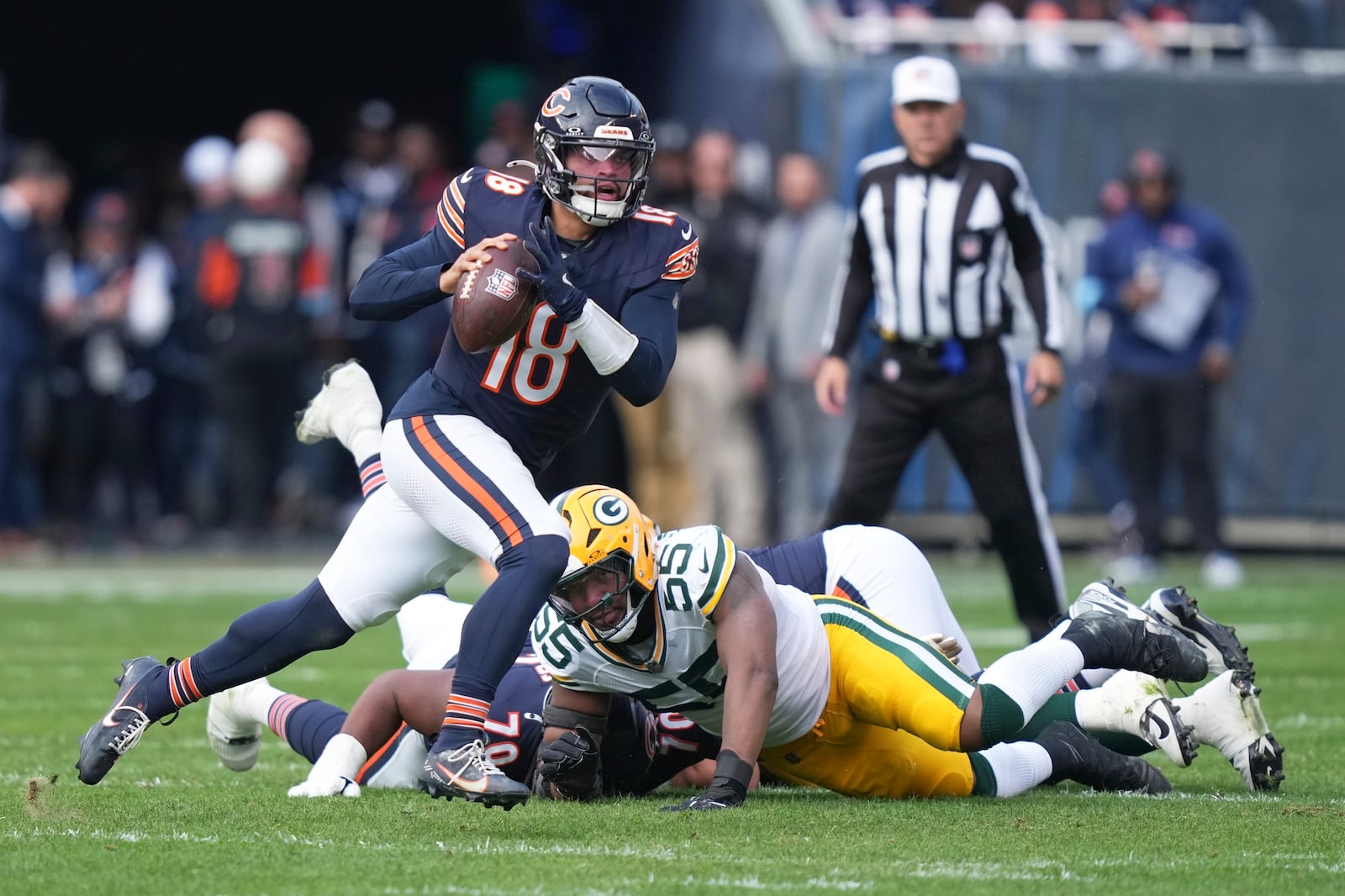 Chicago Bears' Caleb Williams runs during the first half of an NFL football game against the Green Bay Packers Sunday, Nov. 17, 2024, in Chicago. (AP Photo/Charles Rex Arbogast)