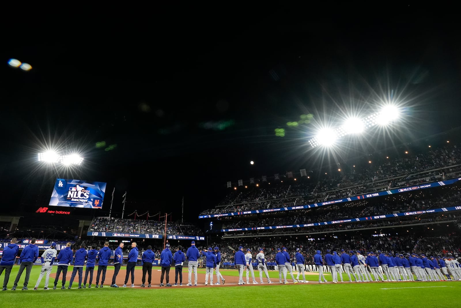 The New York Mets line up for introductions before Game 3 of a baseball NL Championship Series against the Los Angeles Dodgers, Wednesday, Oct. 16, 2024, in New York. (AP Photo/Frank Franklin II)