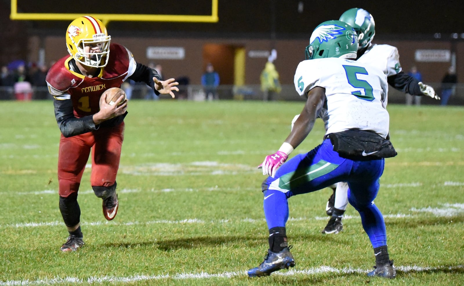 Fenwick’s Thomas Vogelsang (11) looks for yards after a catch as Chaminade Julienne’s Marquis George (5) defends during Friday night’s Division III, Region 12 playoff game at Krusling Field in Middletown. Fenwick won 28-7. CONTRIBUTED PHOTO BY ANGIE MOHRHAUS