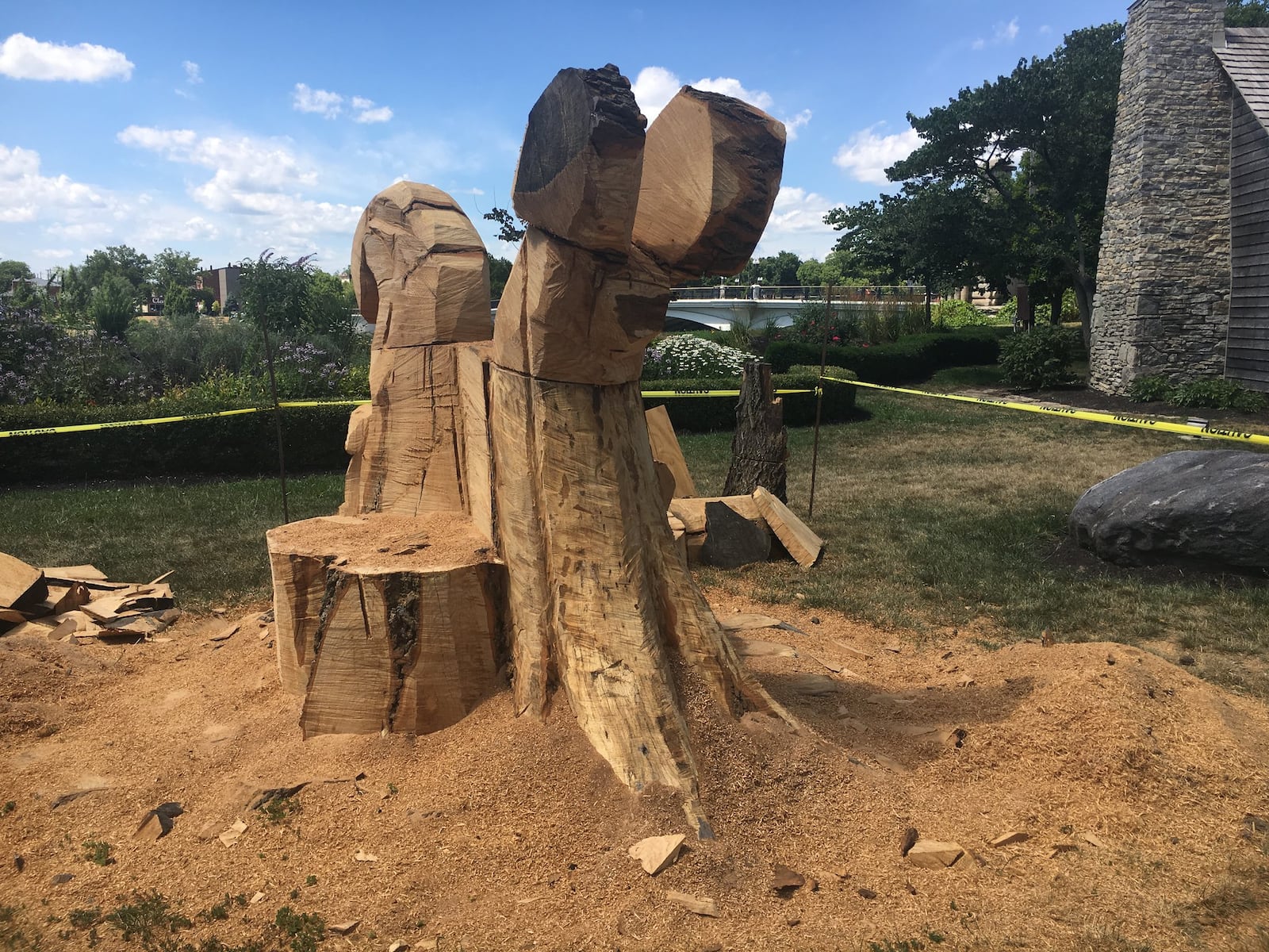 The base of an oak tree, which once stood between the Fitton Center and the Hamilton Monument on Monument Avenue, is being carved into a sculptural bench.