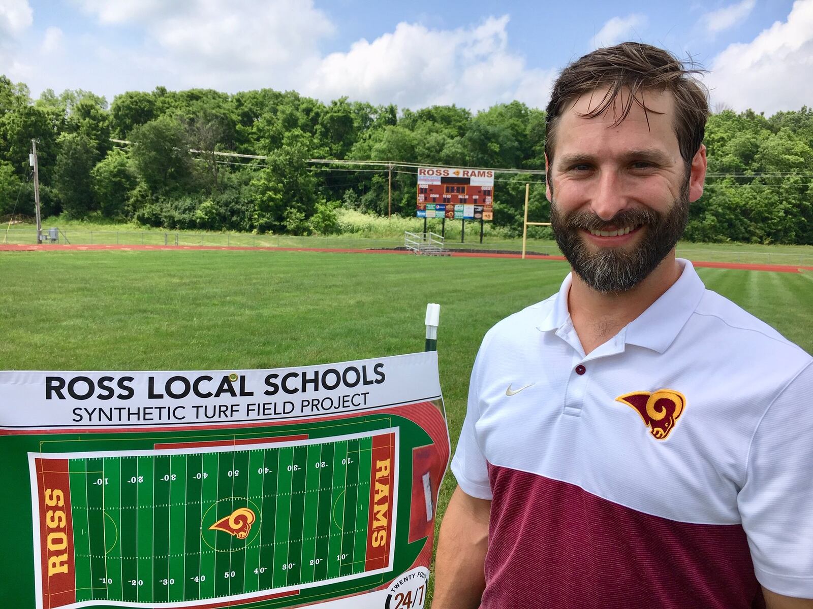 Ross Schools Athletic Director Jake Richards stands for one of the last times on the Butler County school district’s grass sports field. Richards led a ceremonial ground breaking Wednesday celebrating the coming installation of the first artificial turf field in the school system’s history.