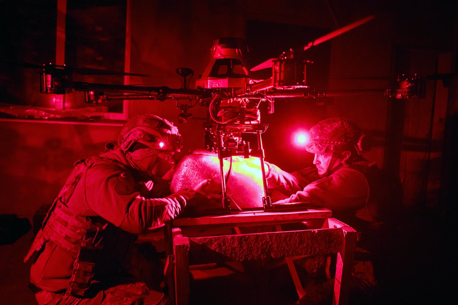 Servicemen of Ukraine's Khartia brigade pack a Vampire drone with food and water to launch toward the frontline to Ukrainian positions near Kharkiv, Ukraine, late Thursday, Nov. 7, 2024. (AP Photo/Efrem Lukatsky)