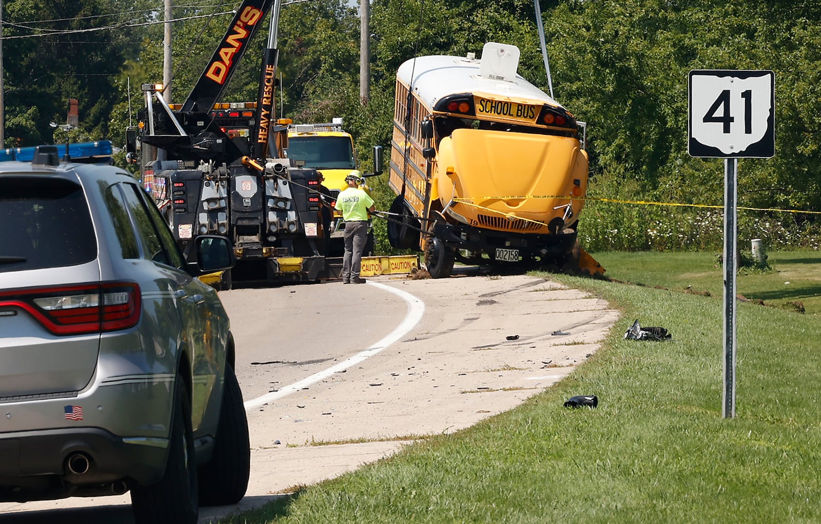 A Northwestern School District bus is uprighted by a crane after it was involved in a crash with another vehicle and rolled over. Twenty three children were transported to the hospital after the crash and one child was killed when they were ejected. BILL LACKEY/STAFF