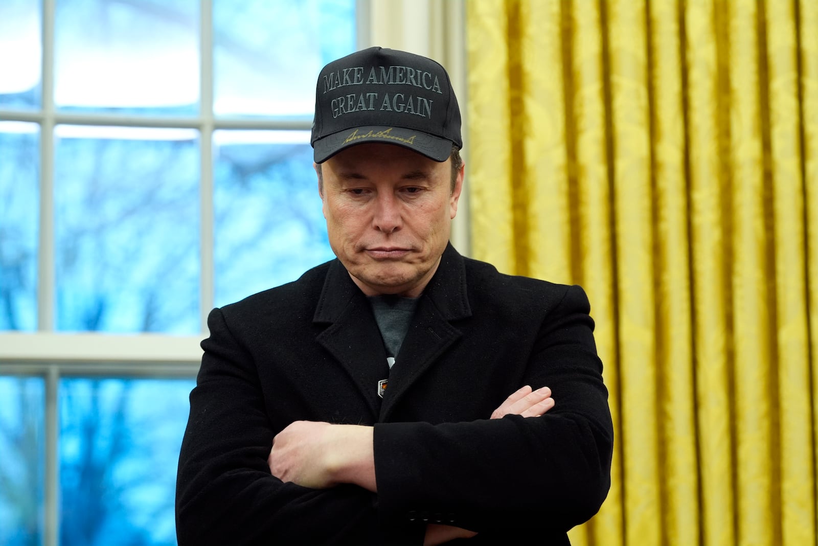 Elon Musk listens as President Donald Trump speaks with reporters in the Oval Office at the White House, Tuesday, Feb. 11, 2025, in Washington. (Photo/Alex Brandon)