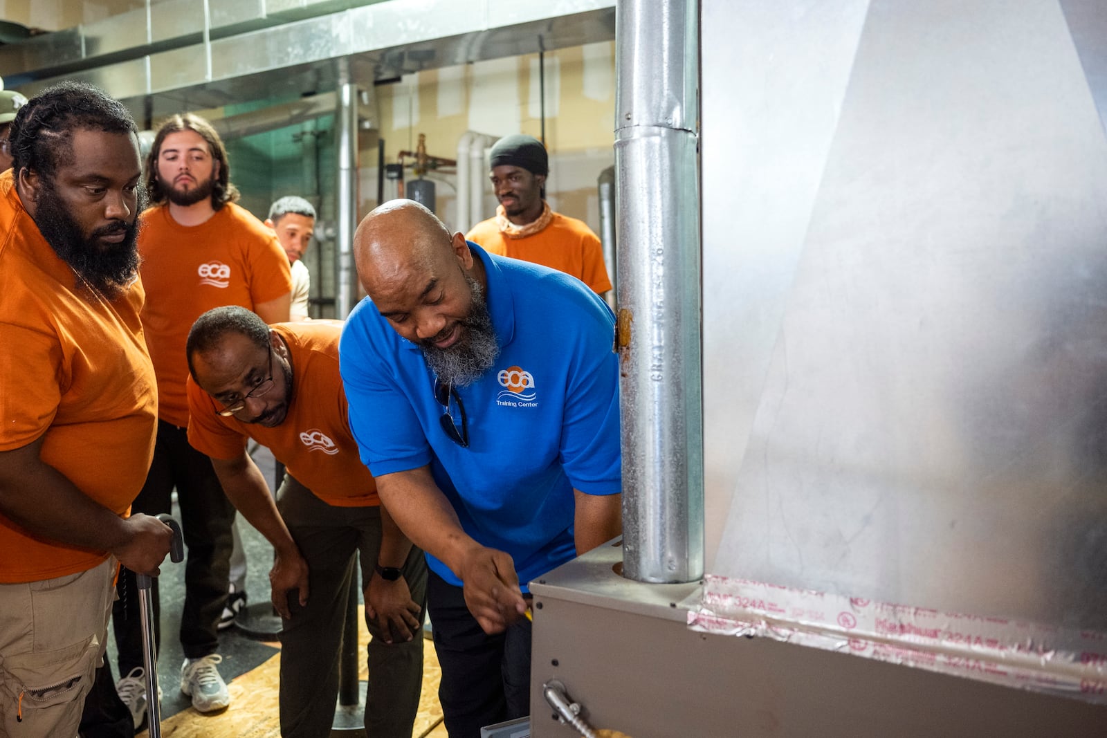 Jackie Robinson, an instructor at the Energy Coordinating Agency, a nonprofit focused in part on energy equity, teaches a class at the facility on Tuesday, July 2, 2024, in Philadelphia. (AP Photo/Joe Lamberti)