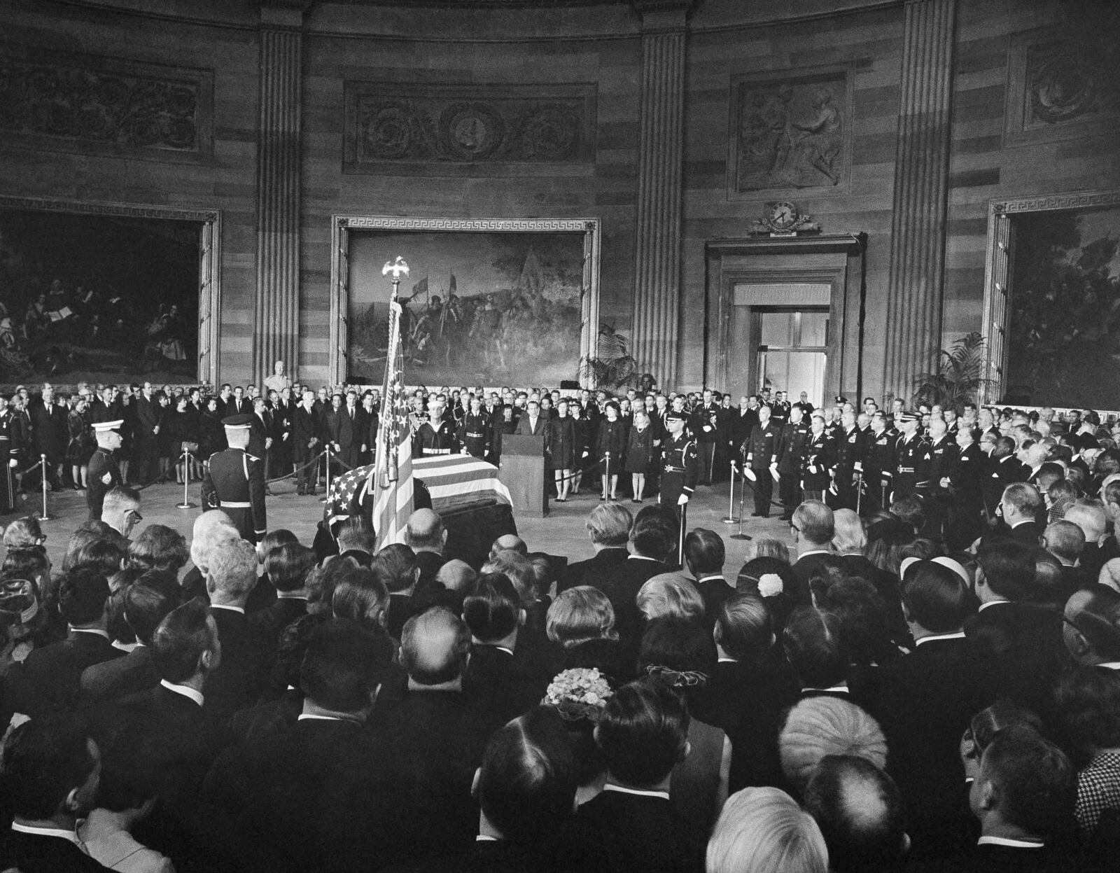 FILE - President Richard Nixon, center, speaks from a podium in front of the casket of Dwight D. Eisenhower in the Capitol Rotunda in Washington, March 30, 1969. From left, front: former first lady Mamie Eisenhower, the widow; son John Eisenhower and his wife, Barbara Eisenhower; first lady Pat Nixon and daughter Tricia. (AP Photo, File)