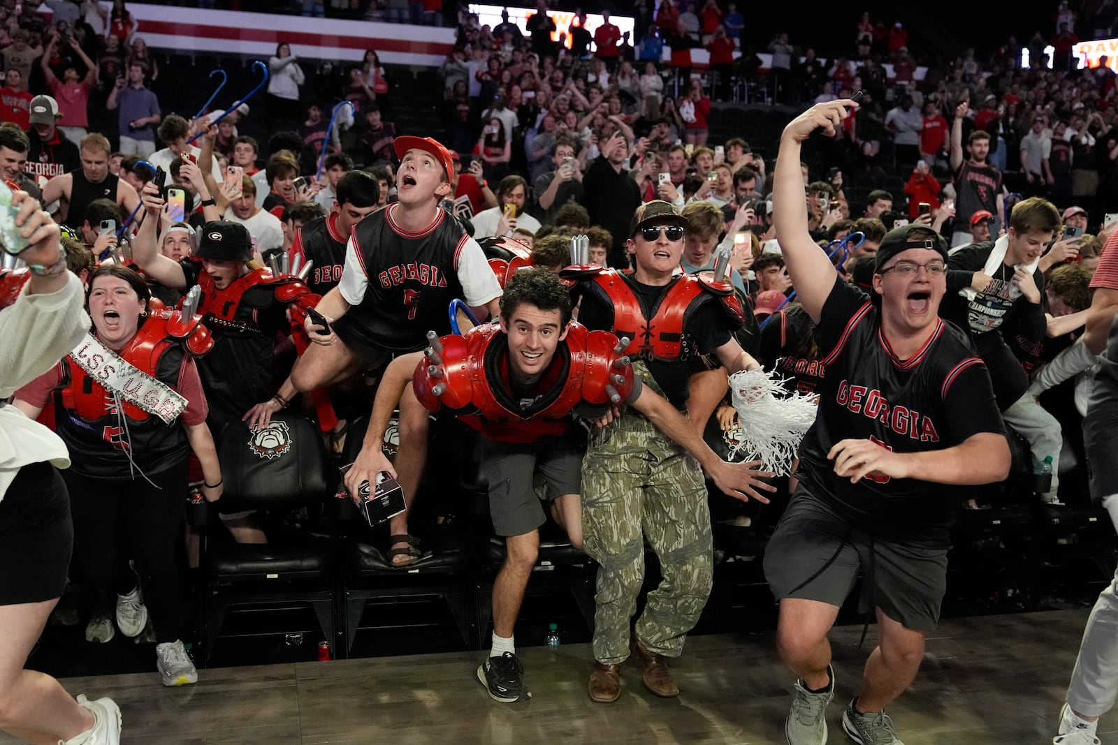 Georgia fans rush the court in celebration after an NCAA college basketball game against Florida, Tuesday, Feb. 25, 2025, in Athens, Ga. (AP Photo/Brynn Anderson)