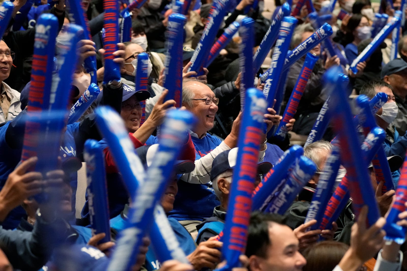 People watch a live stream before the start of Game 3 of the baseball World Series between the Los Angeles Dodgers and the New York Yankees during a public viewing event in Oshu, northeastern Japan, the hometown of Shohei Ohtani of the Dodgers, Tuesday, Oct. 29, 2024. (AP Photo/Eugene Hoshiko)