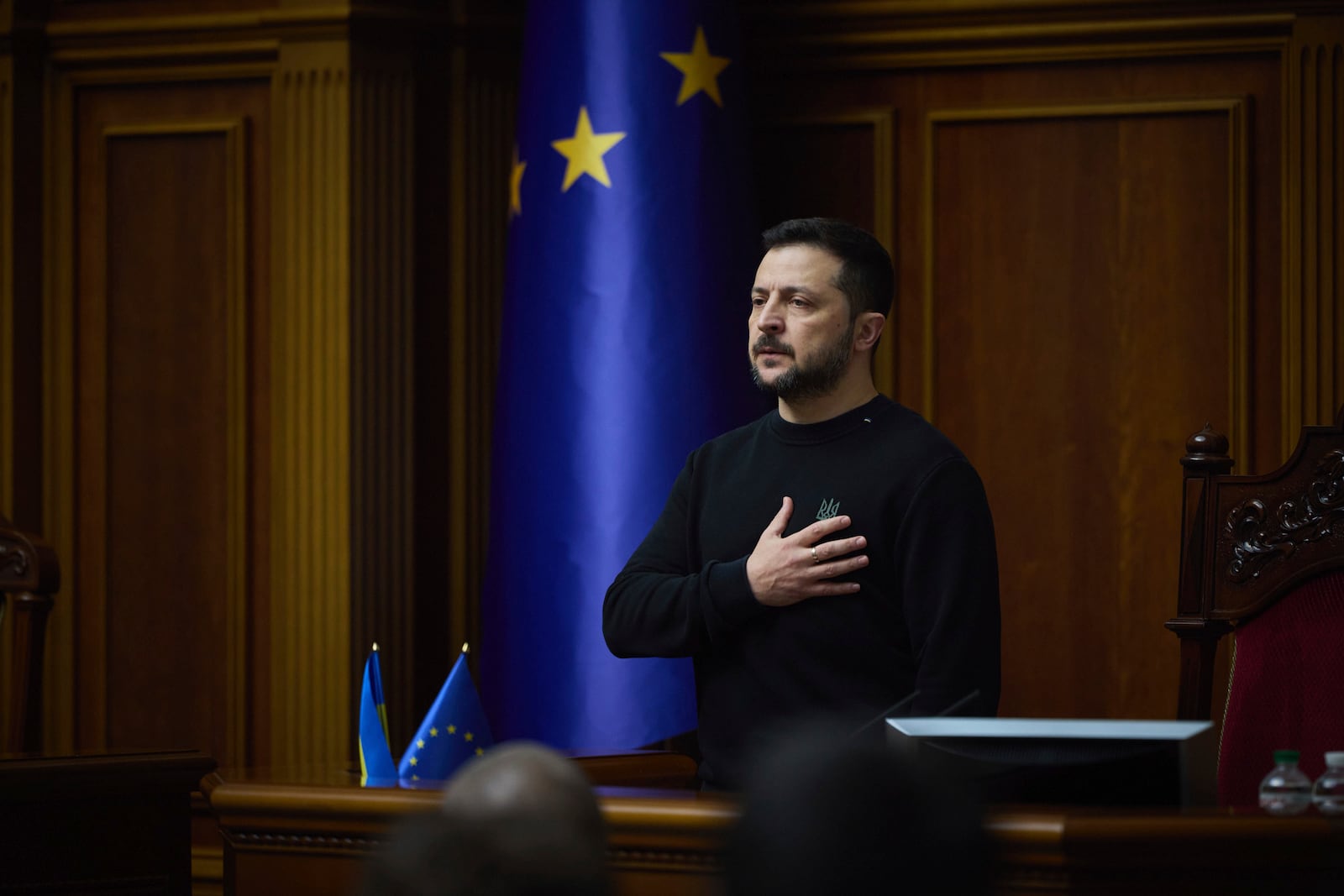 In this photo provided by the Press Service Of The President Of Ukraine on Nov. 19, 2024, Ukraine's President Volodymyr Zelenskyy listens to the national anthem before his speech at Verkhovna Rada in Kyiv, Ukraine. (Press Service Of The President Of Ukraine via AP)