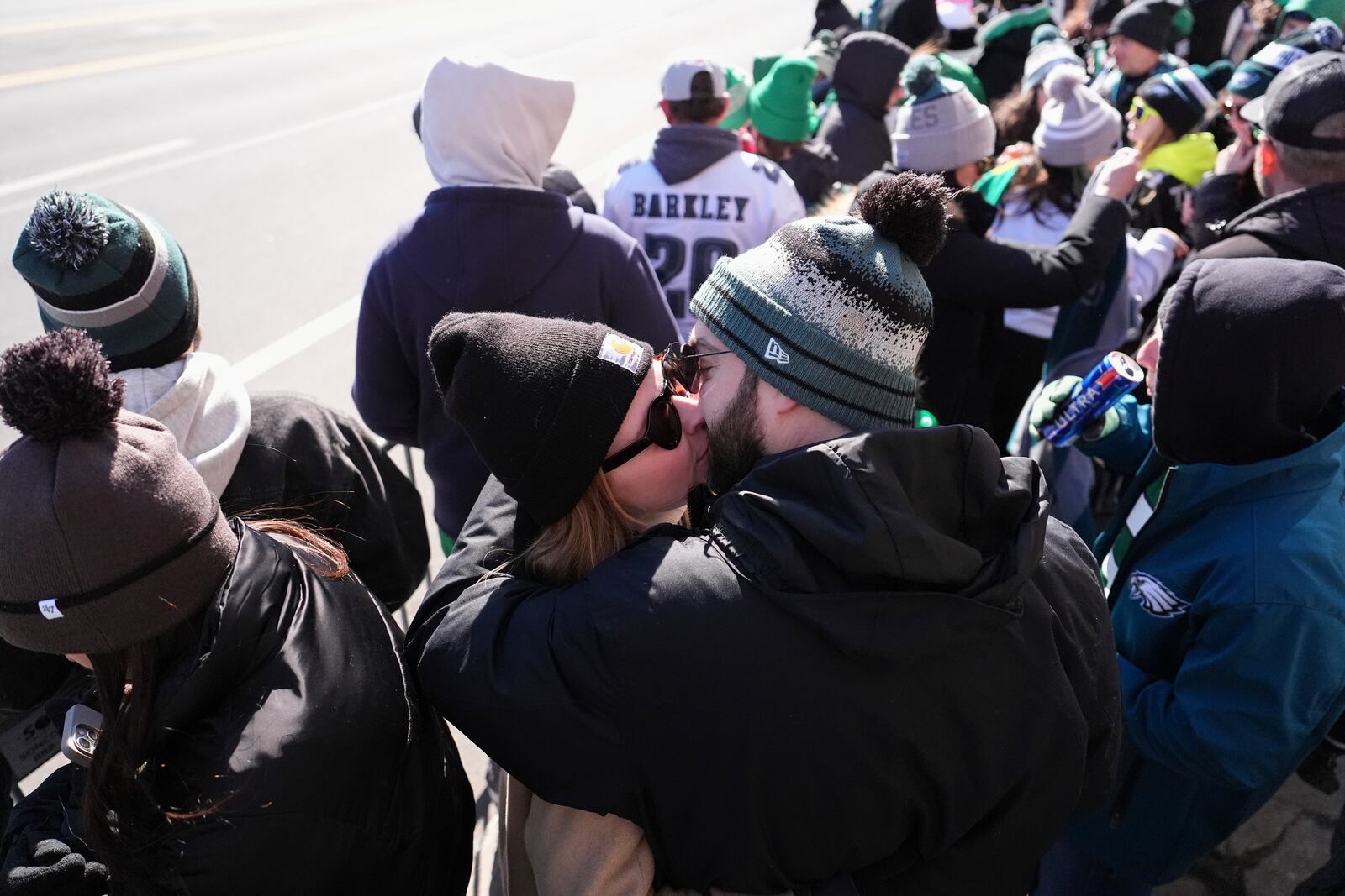 A couple kiss as fans wait before the Philadelphia Eagles' NFL football Super Bowl 59 parade and celebration, Friday, Feb. 14, 2025, in Philadelphia. (AP Photo/Matt Slocum)