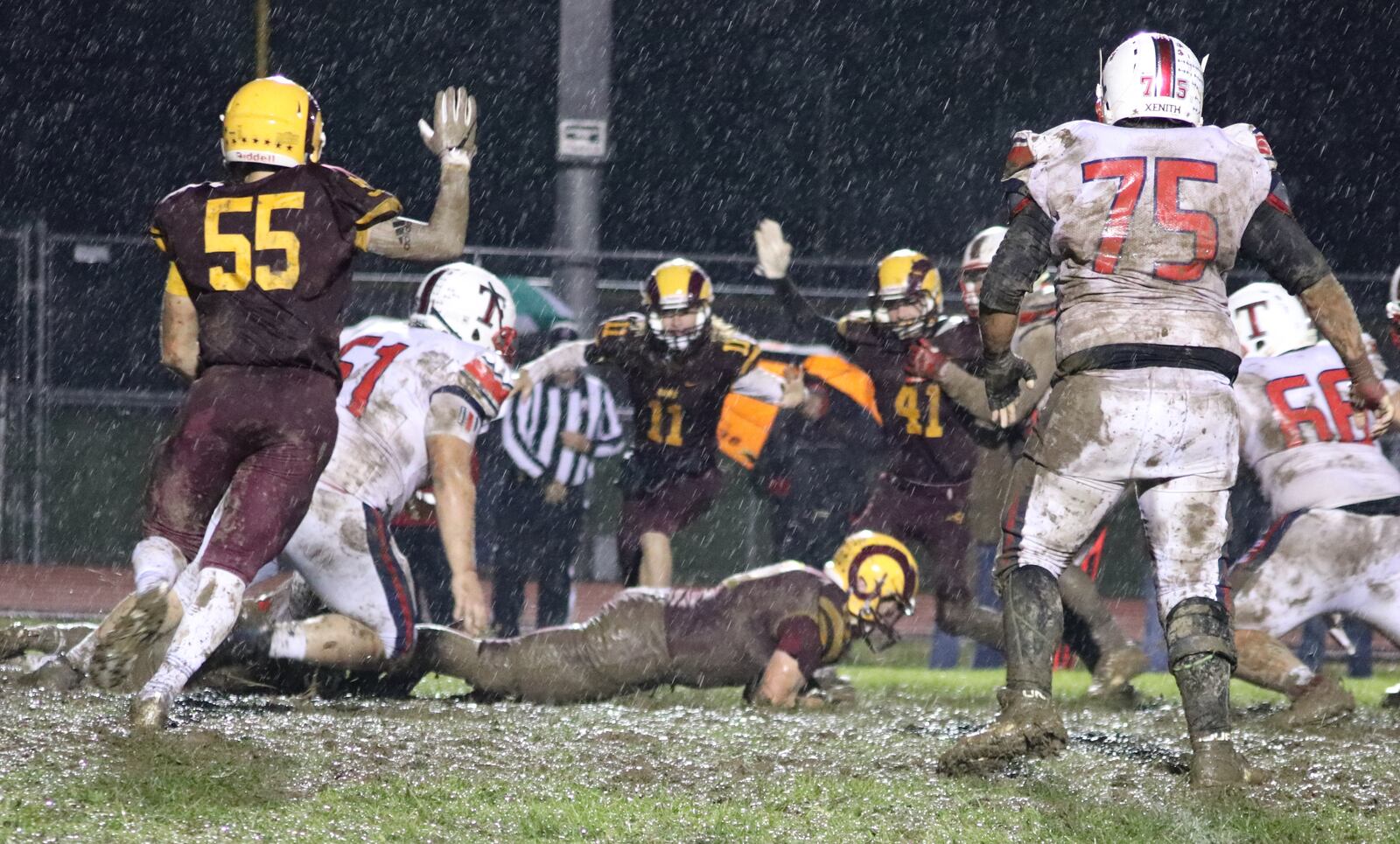 Andrew Redemeier of Ross recovers a fumble as he’s surrounded by teammates Jack DePrie (55), Jordan Hodge (11) and Will Palmer (41) during Friday night’s game against visiting Talawanda at Robinson Field in Ross Township. On the play for the Braves are Ryan McGuire (61) and Andrew Marcum (75). Ross won 18-7. CONTRIBUTED PHOTO BY KAREN REDEMEIER