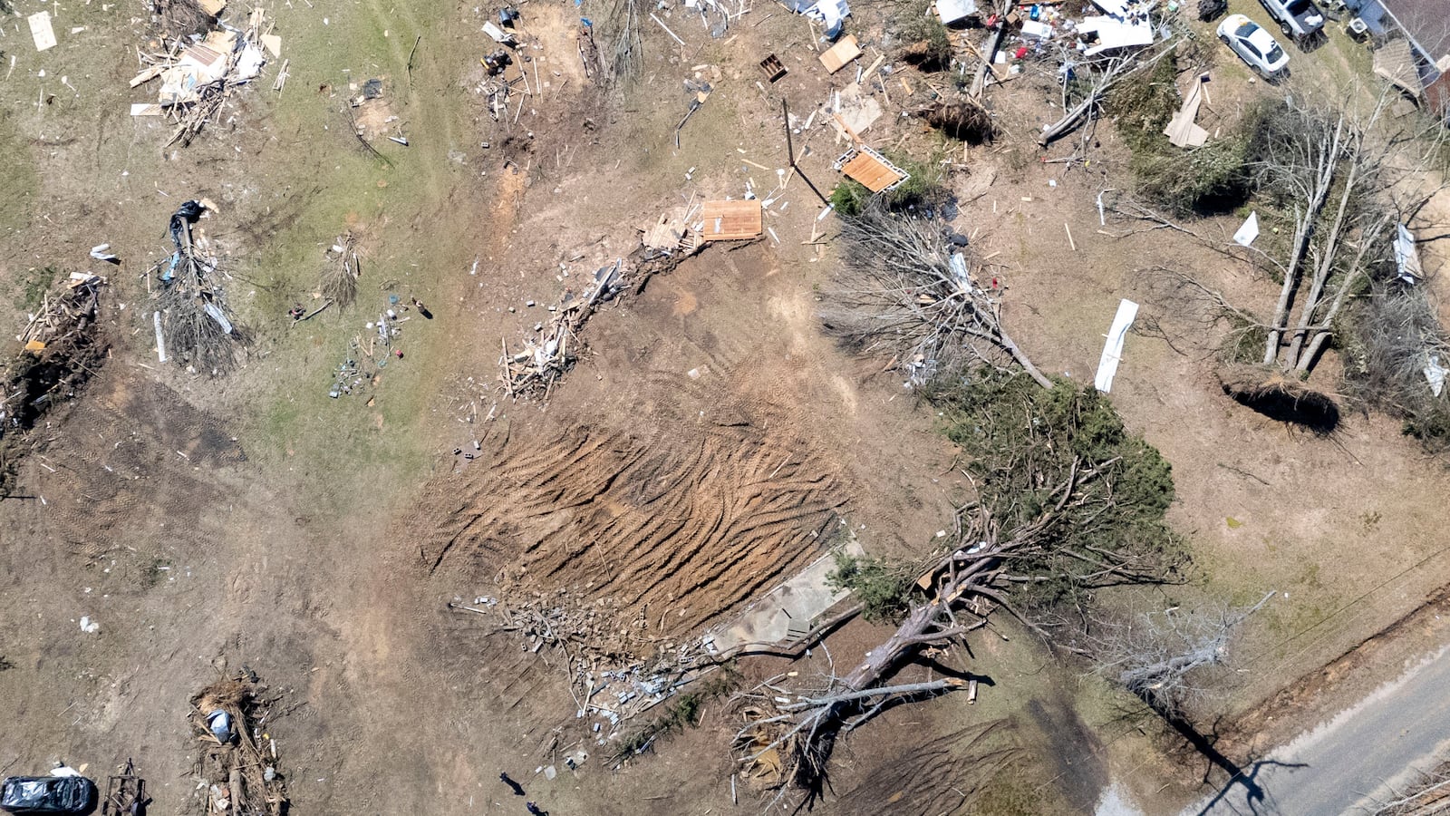 This image taken with a drone shows storm damage from what's left of Annie Free's home at the Lovelady Lane and Dallas County 63 interchange, Monday, March 17, 2025, in Plantersville, Ala. Annie Free, 82, died Saturday after a Tornado struck her home, leaving only the front patio behind. (AP Photo/Vasha Hunt)