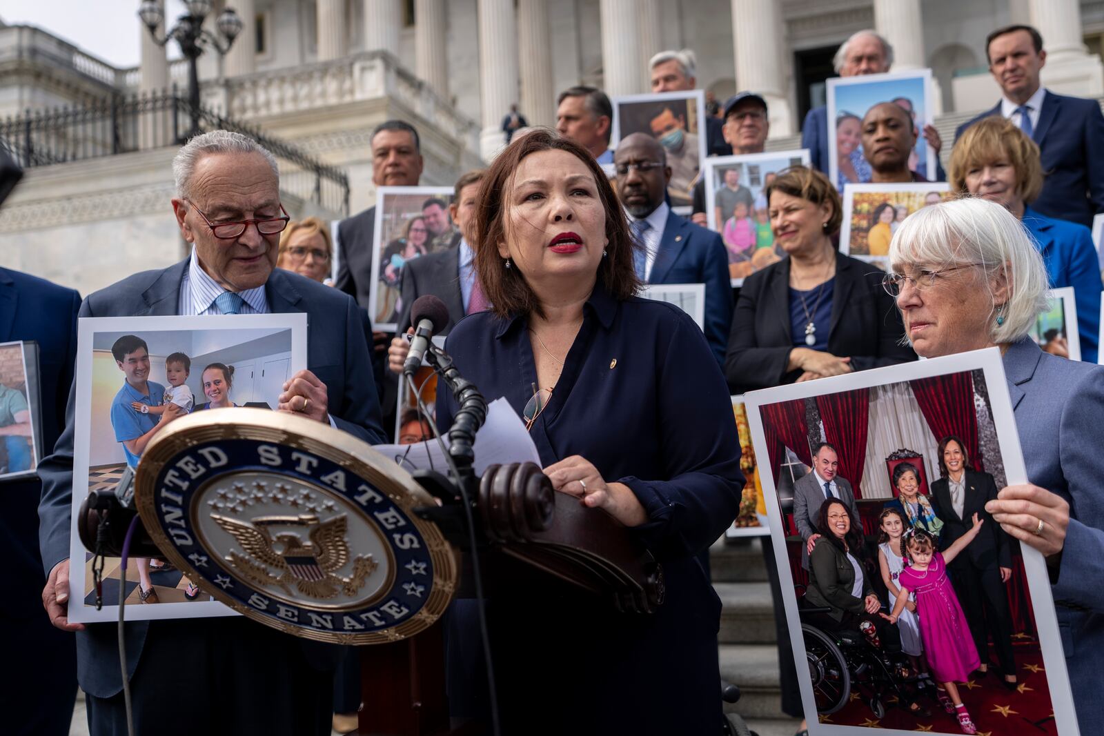 Sen. Tammy Duckworth, D-Ill., center, accompanied by Senate Majority Leader Chuck Schumer, D-NY, left, and Sen. Patty Murray, D-Wash., right, speaks about the need to protect rights to in vitro fertilization (IVF), on the Senate steps at Capitol Hill in Washington, Tuesday, Sept. 17, 2024. (AP Photo/Ben Curtis)