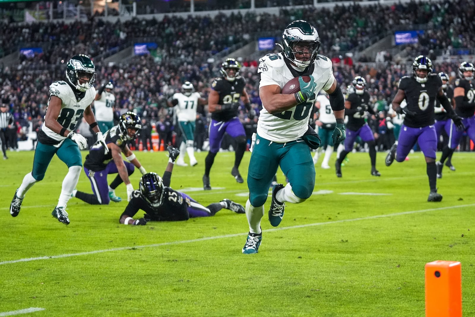 Philadelphia Eagles running back Saquon Barkley runs for a touchdown against the Baltimore Ravens during the second half of an NFL football game, Sunday, Dec. 1, 2024, in Baltimore. (AP Photo/Stephanie Scarbrough)