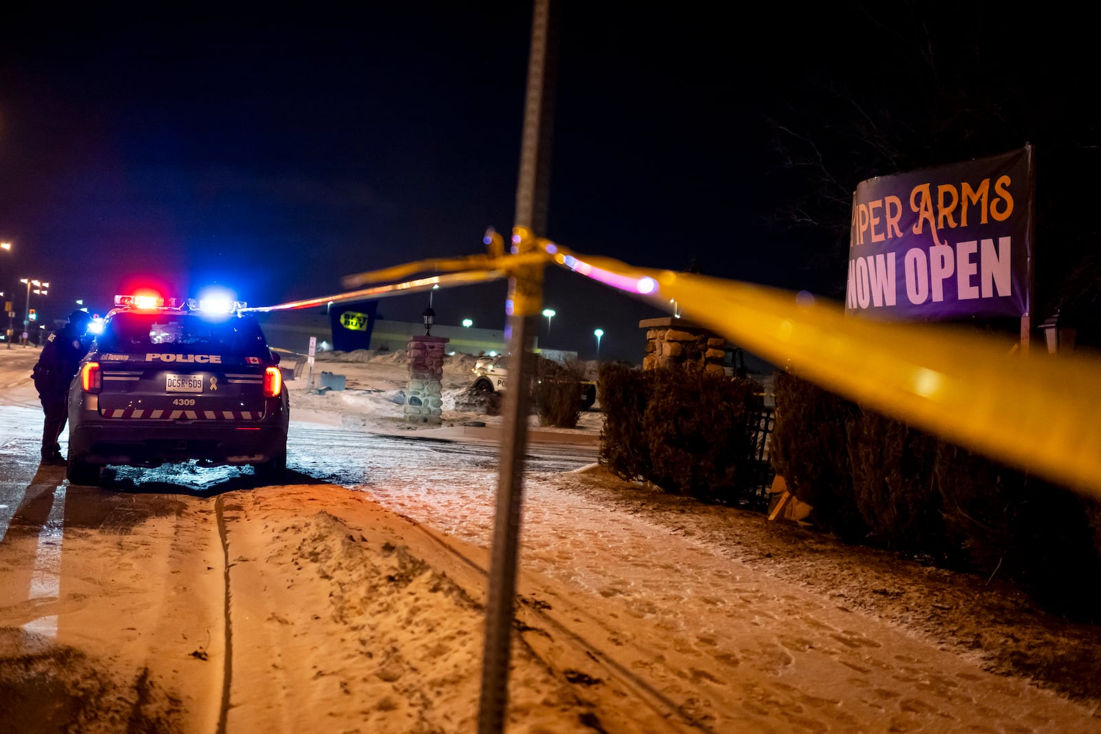 Toronto Police investigate a shooting at the Piper Arms Pub near the Scarborough Town Centre in Toronto on Saturday, March 8, 2025. (Christopher Katsarov/The Canadian Press via AP)