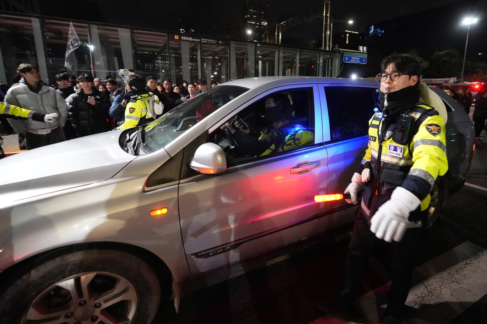 Military vehicles is escorted by police officers outside of the National Assembly in Seoul, South Korea, Wednesday, Dec. 4, 2024. (AP Photo/Lee Jin-man)