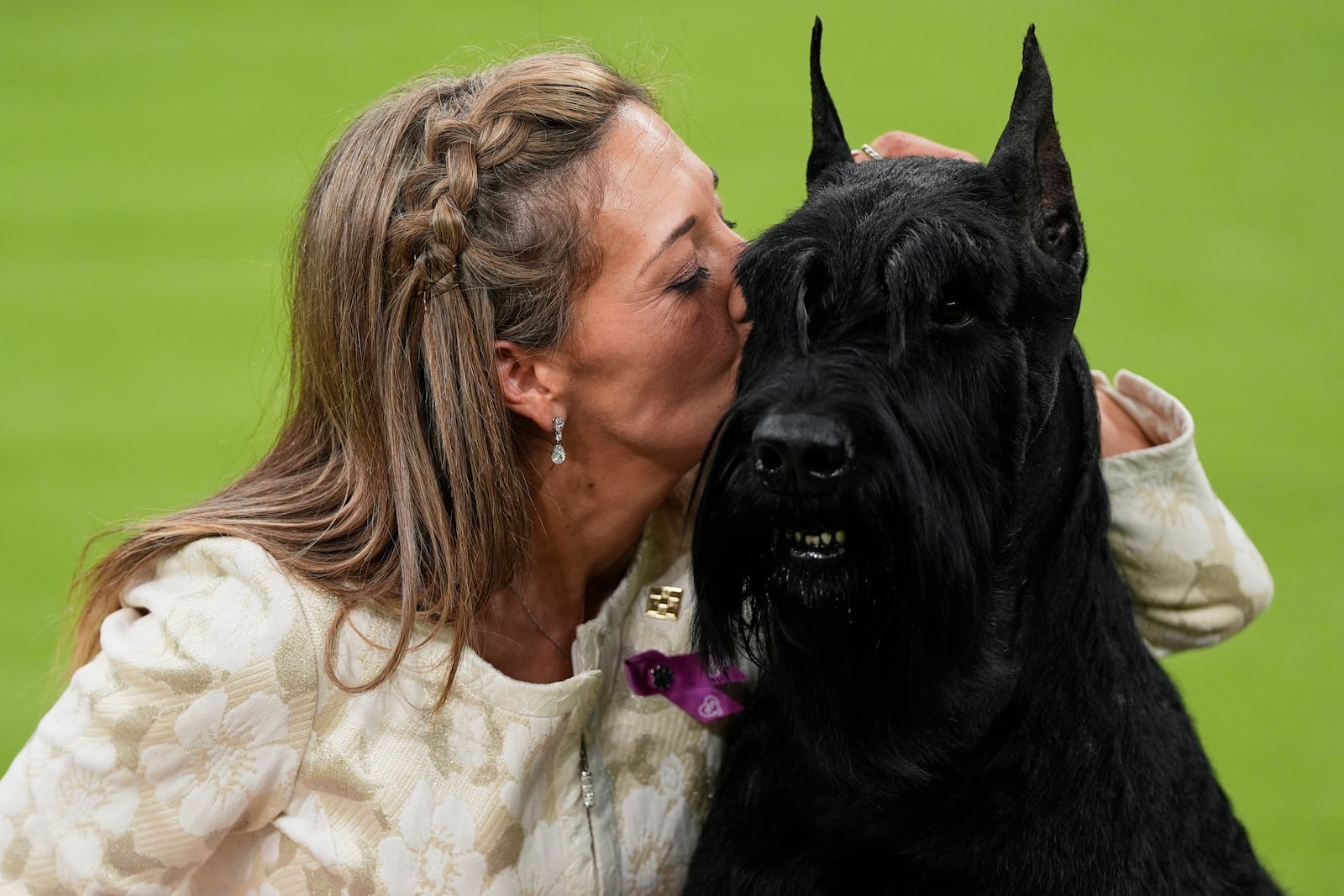 Katie Bernardin kisses Monty, a Giant Schnauzer, after winning best in show in the 149th Westminster Kennel Club Dog show, Tuesday, Feb. 11, 2025, in New York. (AP Photo/Julia Demaree Nikhinson)