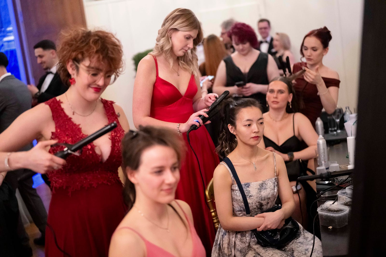 Women adjust each others hair during the Lawyers' Ball in Vienna, Austria, Saturday, March 1, 2025. (AP Photo/Denes Erdos)