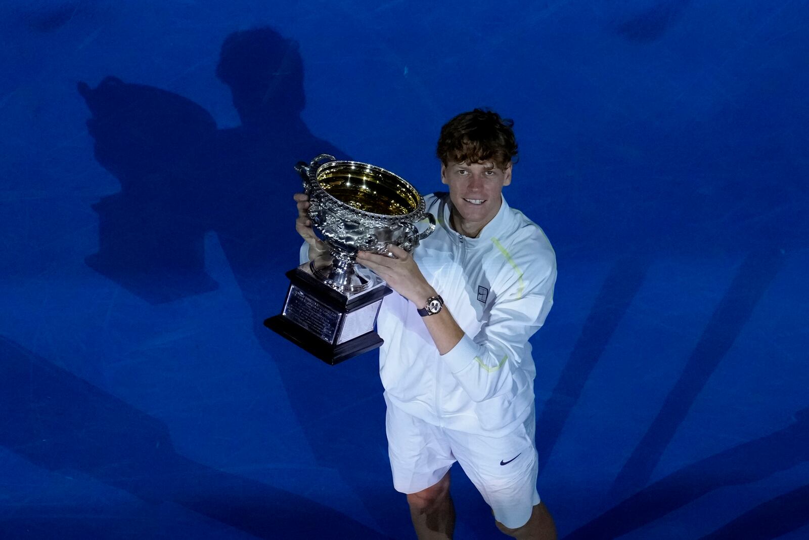 Jannik Sinner of Italy holds the Norman Brookes Challenge Cup after defeating Alexander Zverev of Germany in the men's singles final at the Australian Open tennis championship in Melbourne, Australia, Sunday, Jan. 26, 2025. (AP Photo/Manish Swarup)