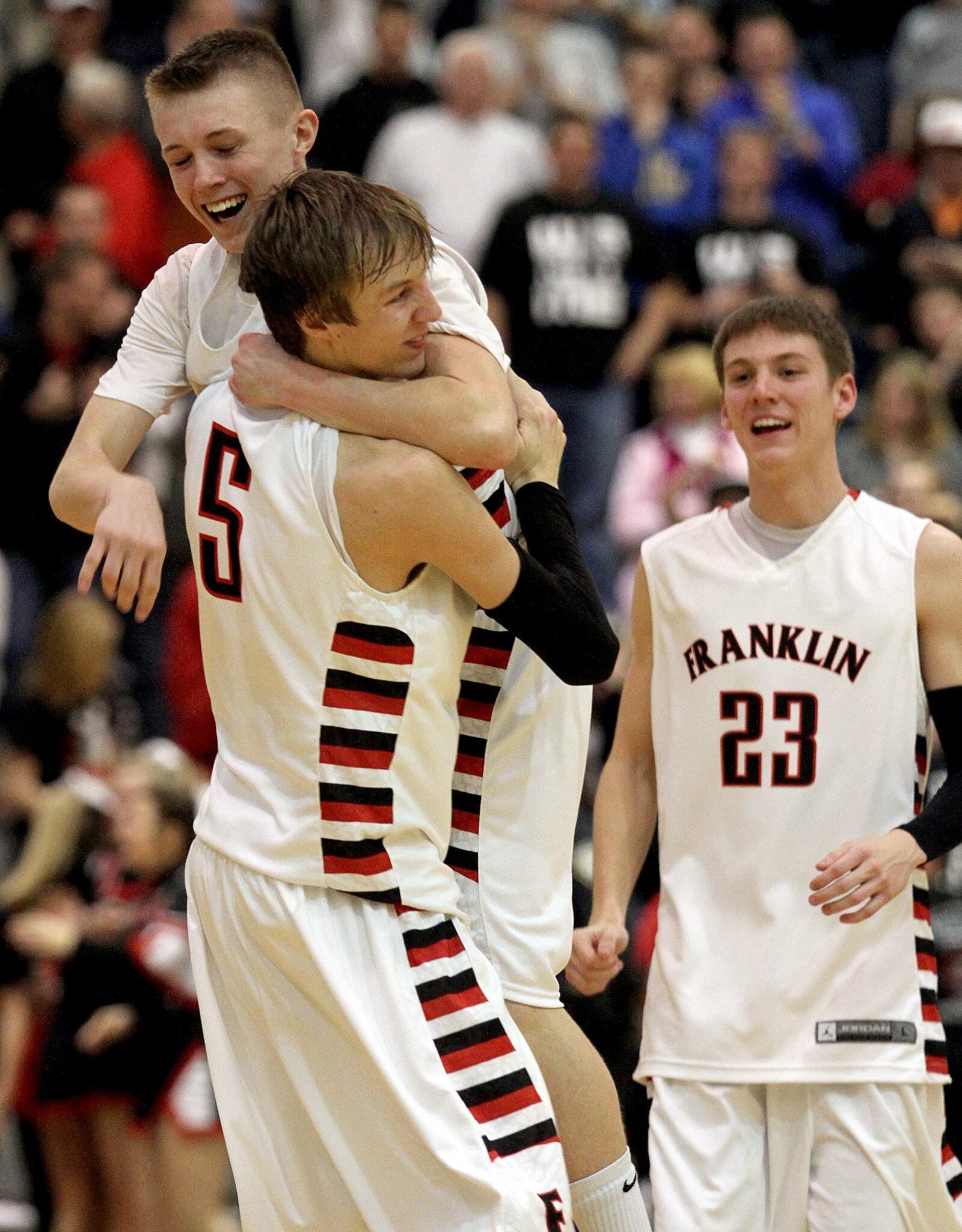 Franklin's Travis Lakins jumps into the arms of teammate Luke Kennard as Tyler Budde watches Tuesday after the Wildcats defeated Chaminade Julienne in triple overtime in their Southwest District sectional game in Kettering. Contributed photo by E.L. Hubbard