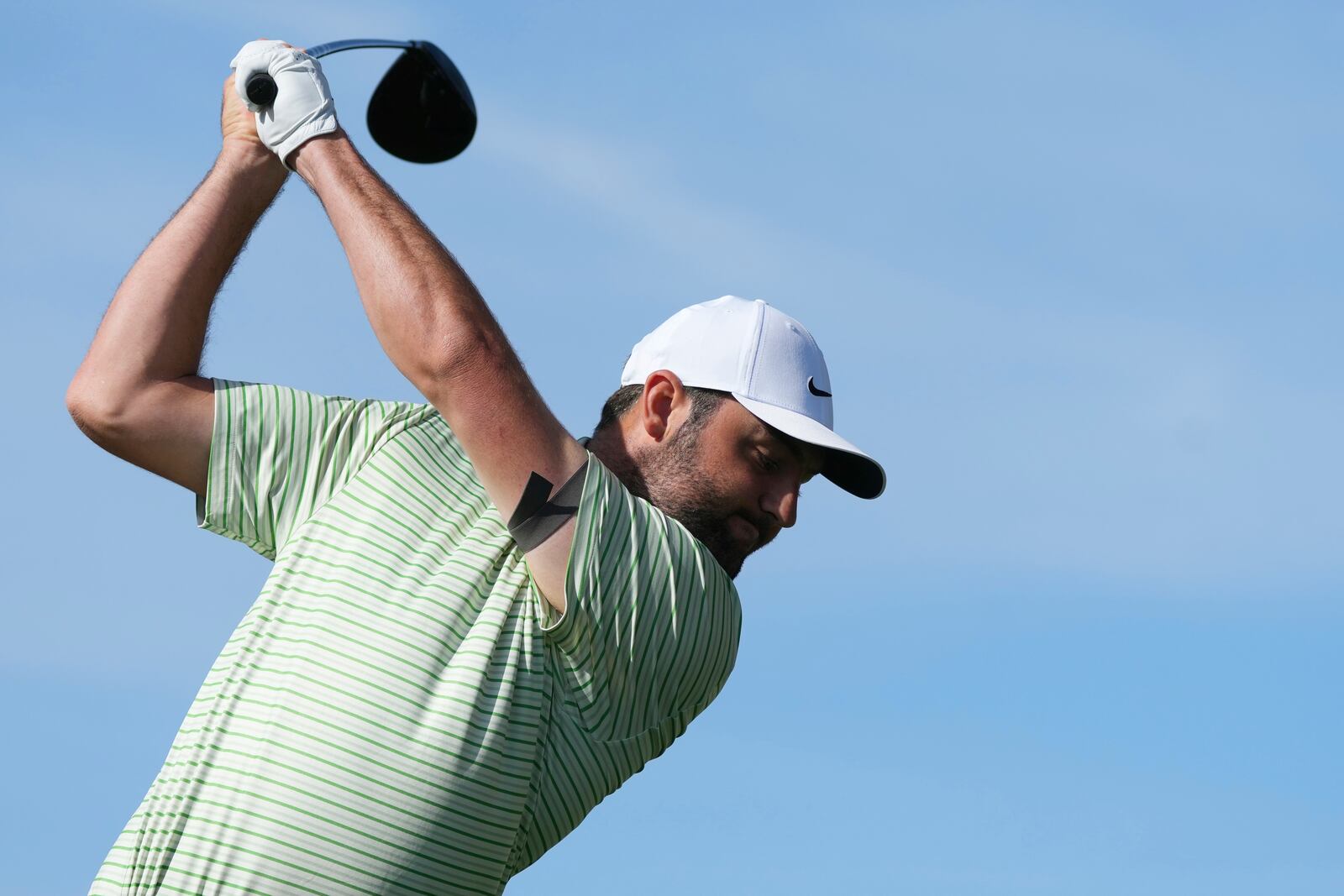 Scottie Scheffler hits his tee shot at the third hole during the third round of the Phoenix Open golf tournament at TPC Scottsdale, Saturday, Feb. 8, 2025, in Scottsdale, Ariz. (AP Photo/Ross D. Franklin)