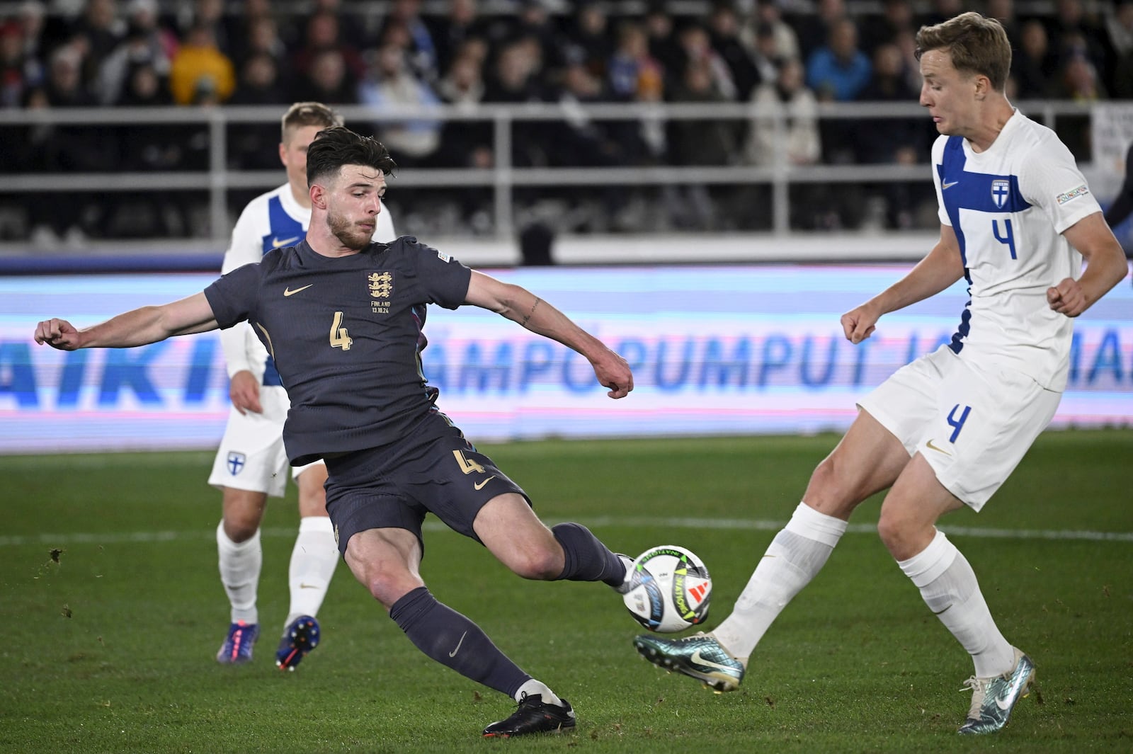 Finland's Robert Ivanov, right, challenges for the ball with England's Declan Rice during the UEFA Nations League soccer match between Finland and England, at the Olympic Stadium in Helsinki, Finland, Sunday, Oct. 13, 2024. (Antti Aimo-Koivisto/Lehtikuva via AP)